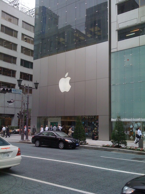 an apple store in front of a big apple building