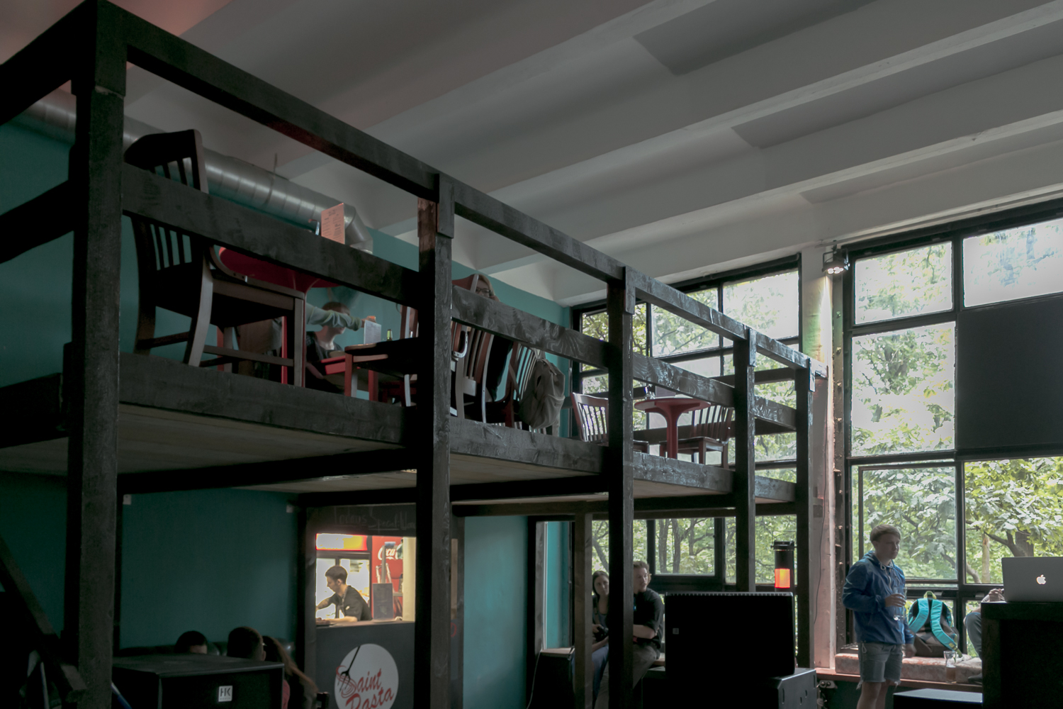 a bedroom with several loft beds, two bunkes, and a ladder leading to a bed