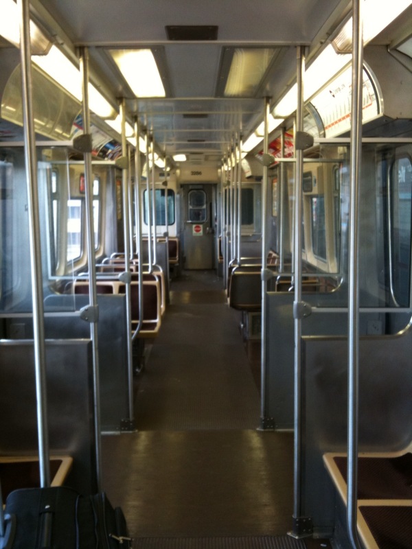 the interior of a train with chairs in the room