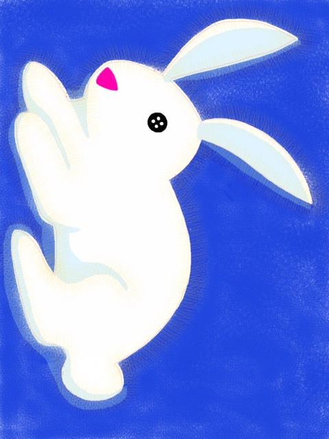 a small white bunny in the middle of blue