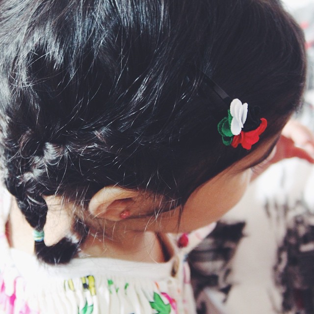 the little girl with long hair has flowers in her hair