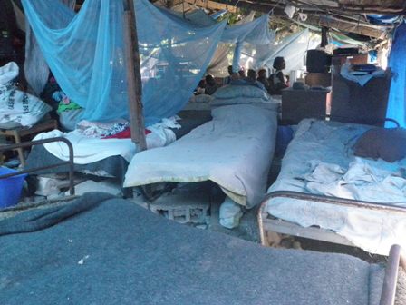 a bunch of beds with tarp around them