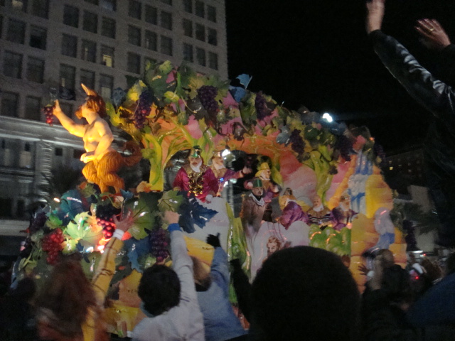 a large float has people on it with other floats behind it