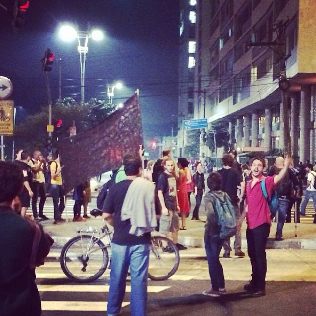 people standing on the side walk near some buildings