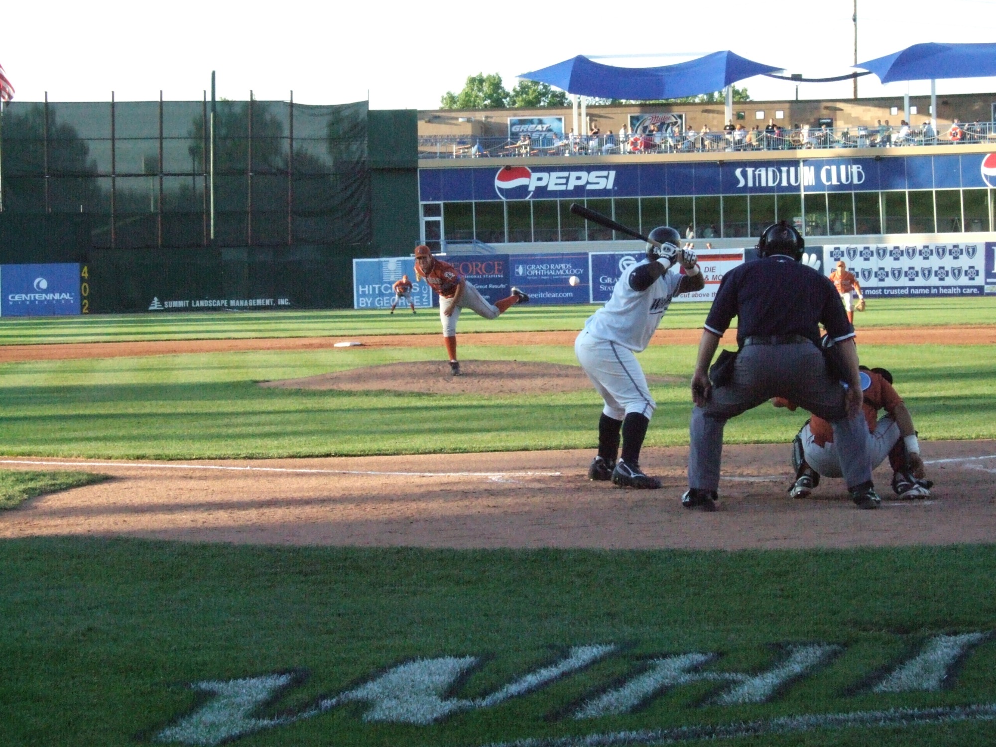 an umpire, catcher and batter in action on a baseball field