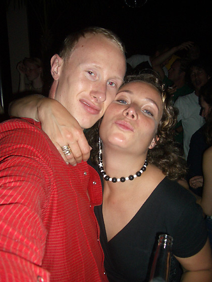 two people standing together at a nightclub