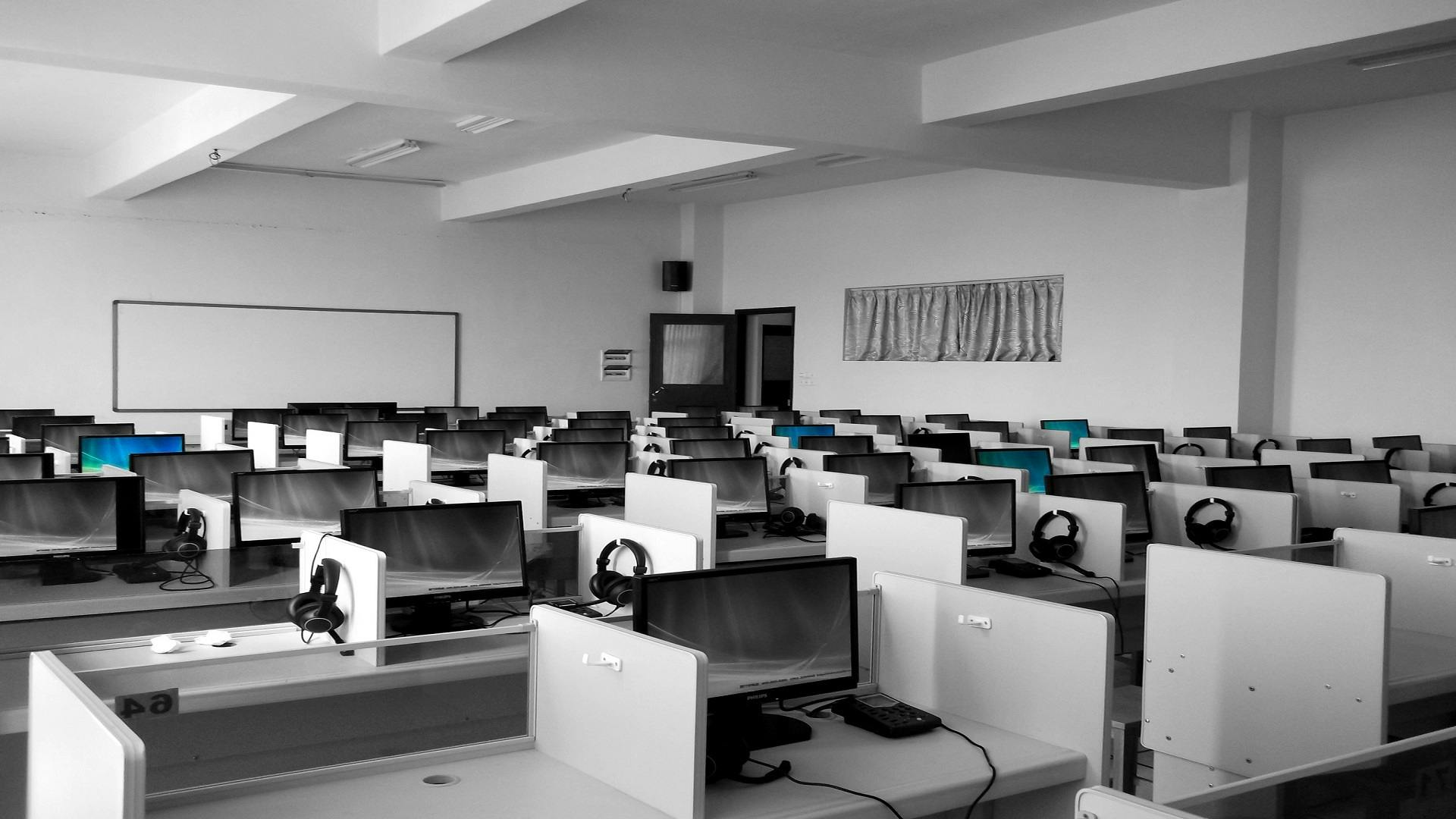 a black and white photo of a classroom with computers, pexels, computer art, in an call centre office, plain background, on a advanced lab, golden computers