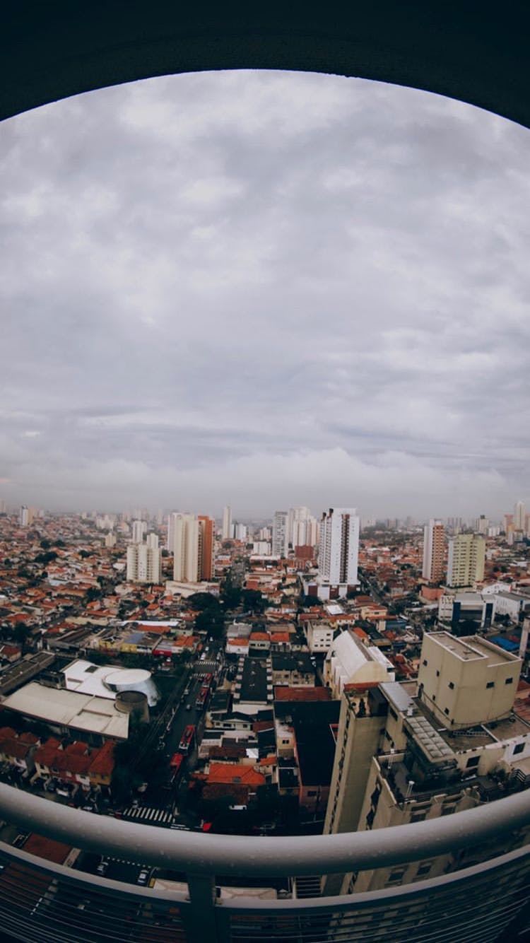 a view of a city from the top of a building, by Lucas Vorsterman, pexels contest winner, happening, brazilian, grey cloudy skies, panoramic widescreen view, square
