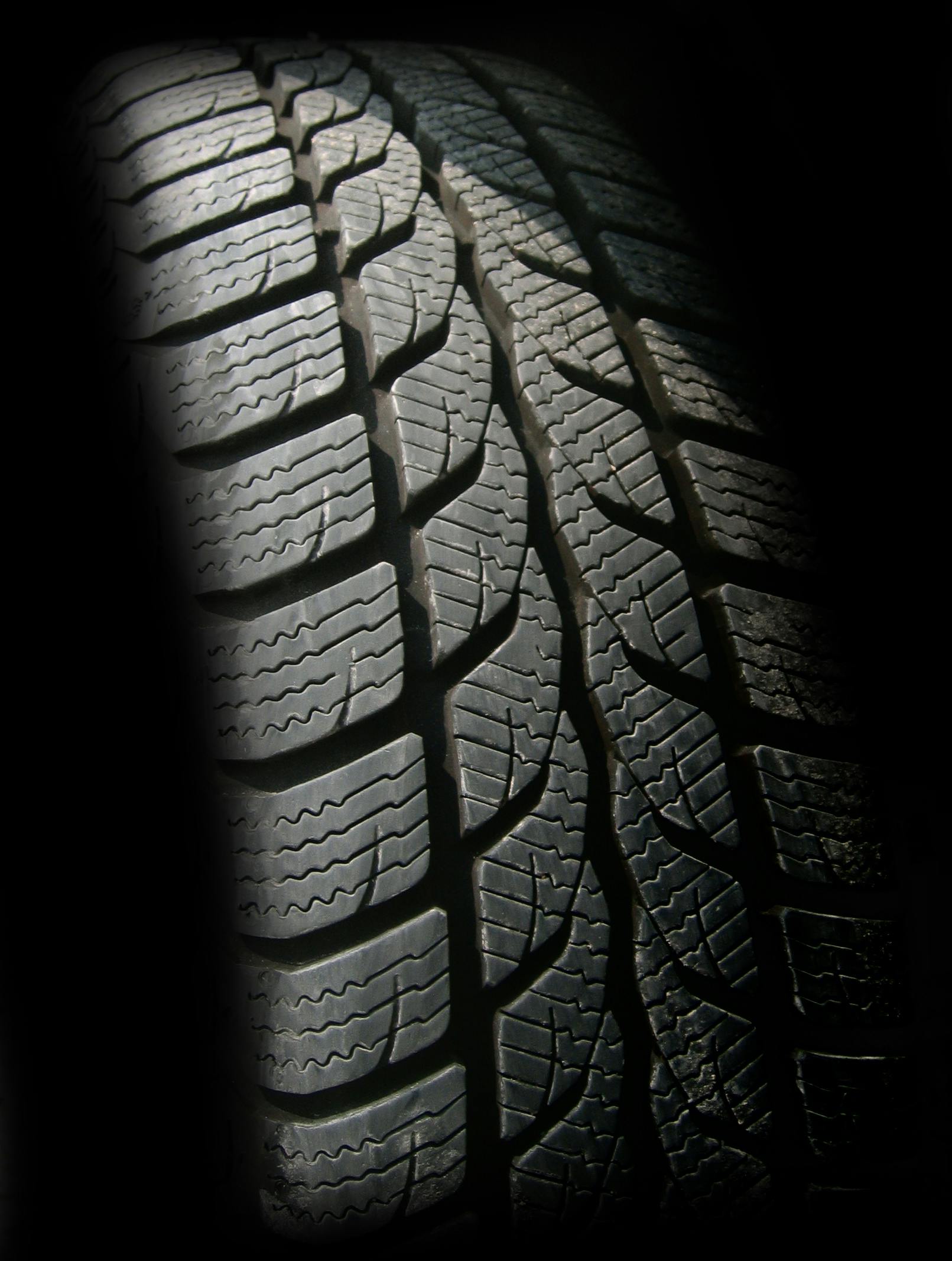 a close up of a tire in the dark, winter sun, thumbnail, hyperdetailed, hires