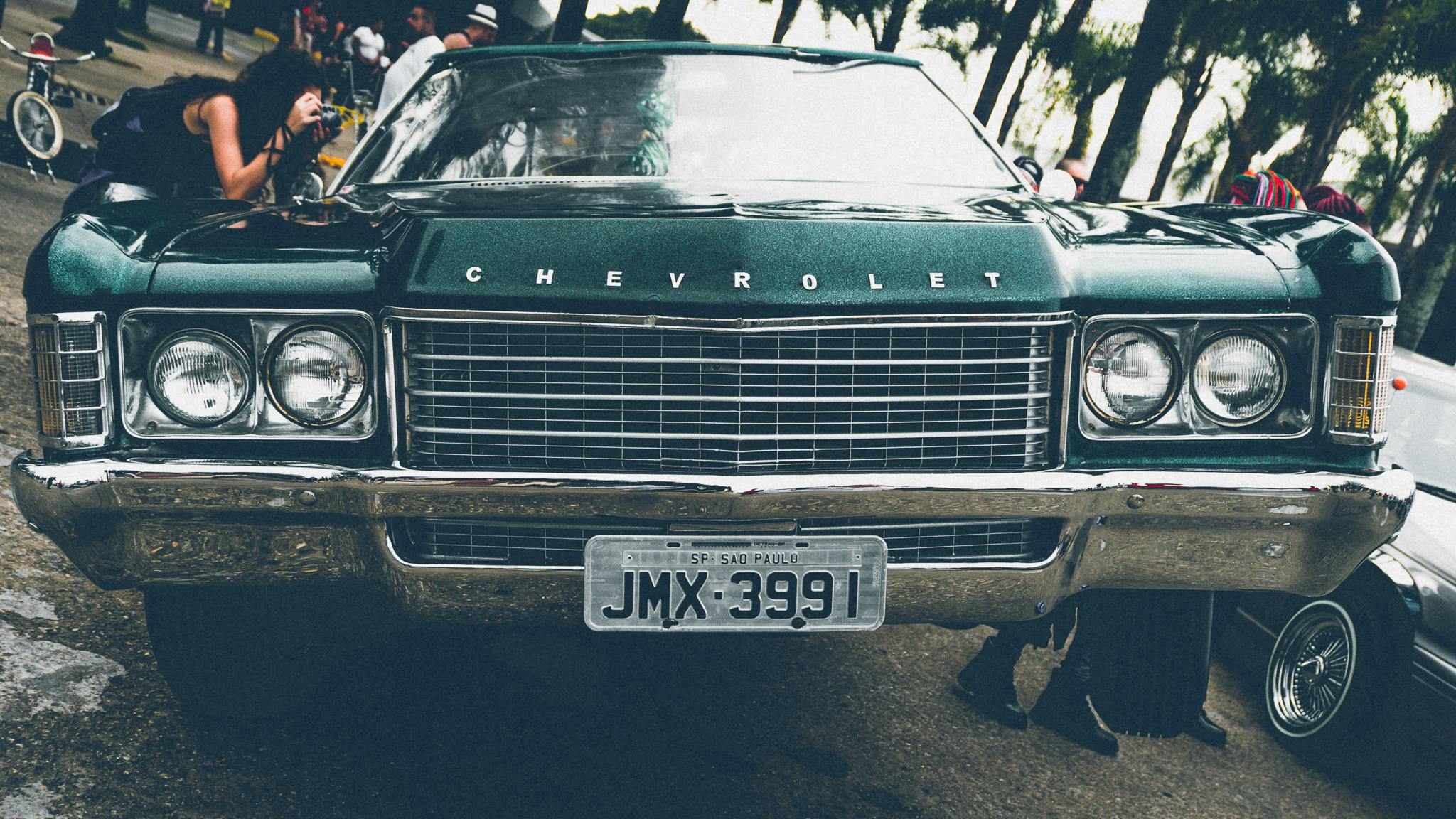 a green car parked on the side of the road, an album cover, by Joe Bowler, pexels contest winner, insanely detailed c 10.0, 🚿🗝📝