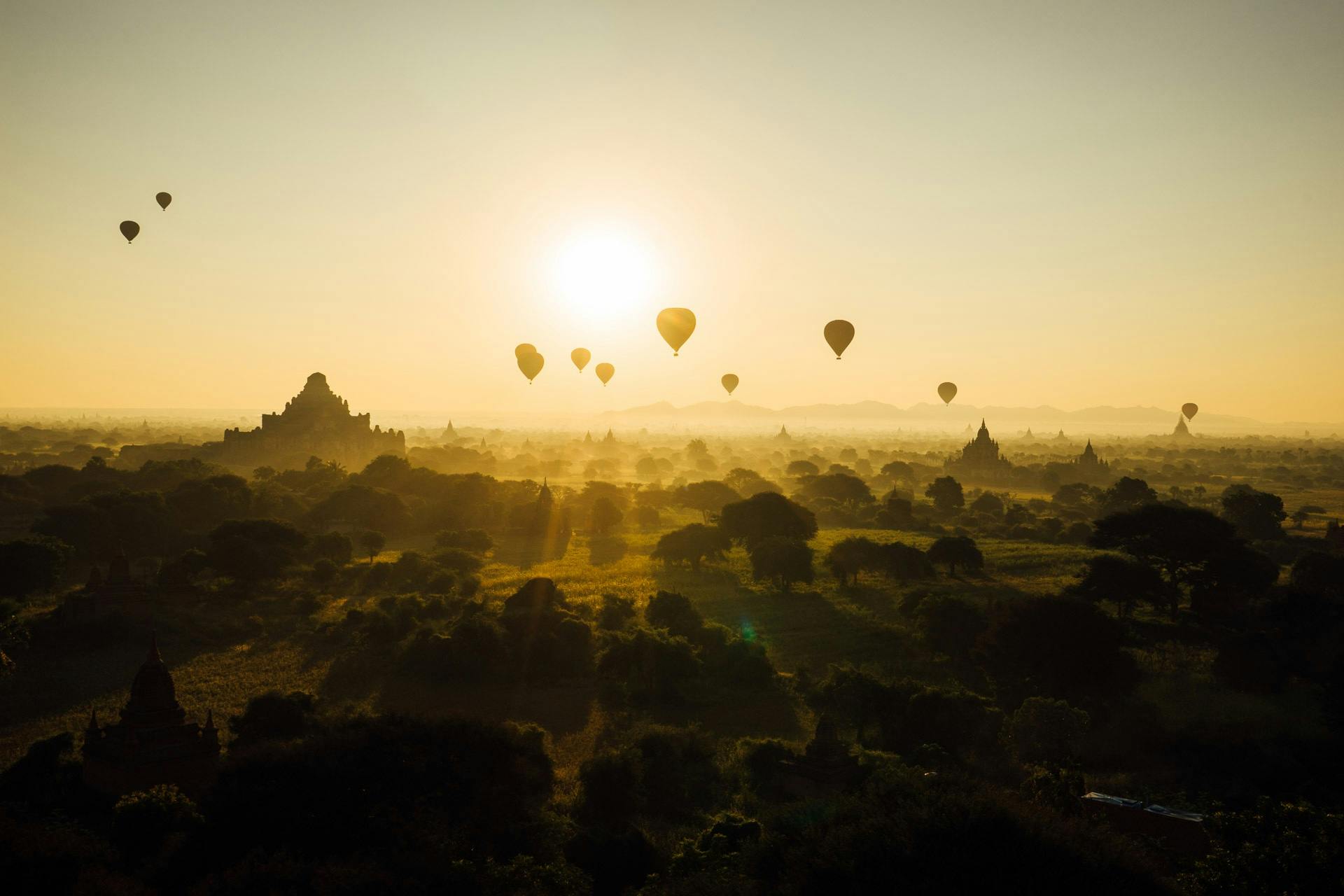 a group of hot air balloons flying in the sky, unsplash contest winner, myanmar, sun behind her, historical photo, 15081959 21121991 01012000 4k
