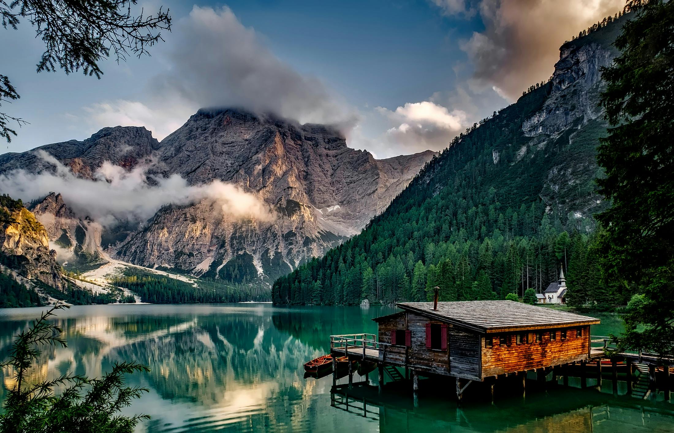 a cabin in the middle of a lake with mountains in the background, pexels contest winner, romanticism, italian masterpiece, brown, conde nast traveler photo, multiple stories