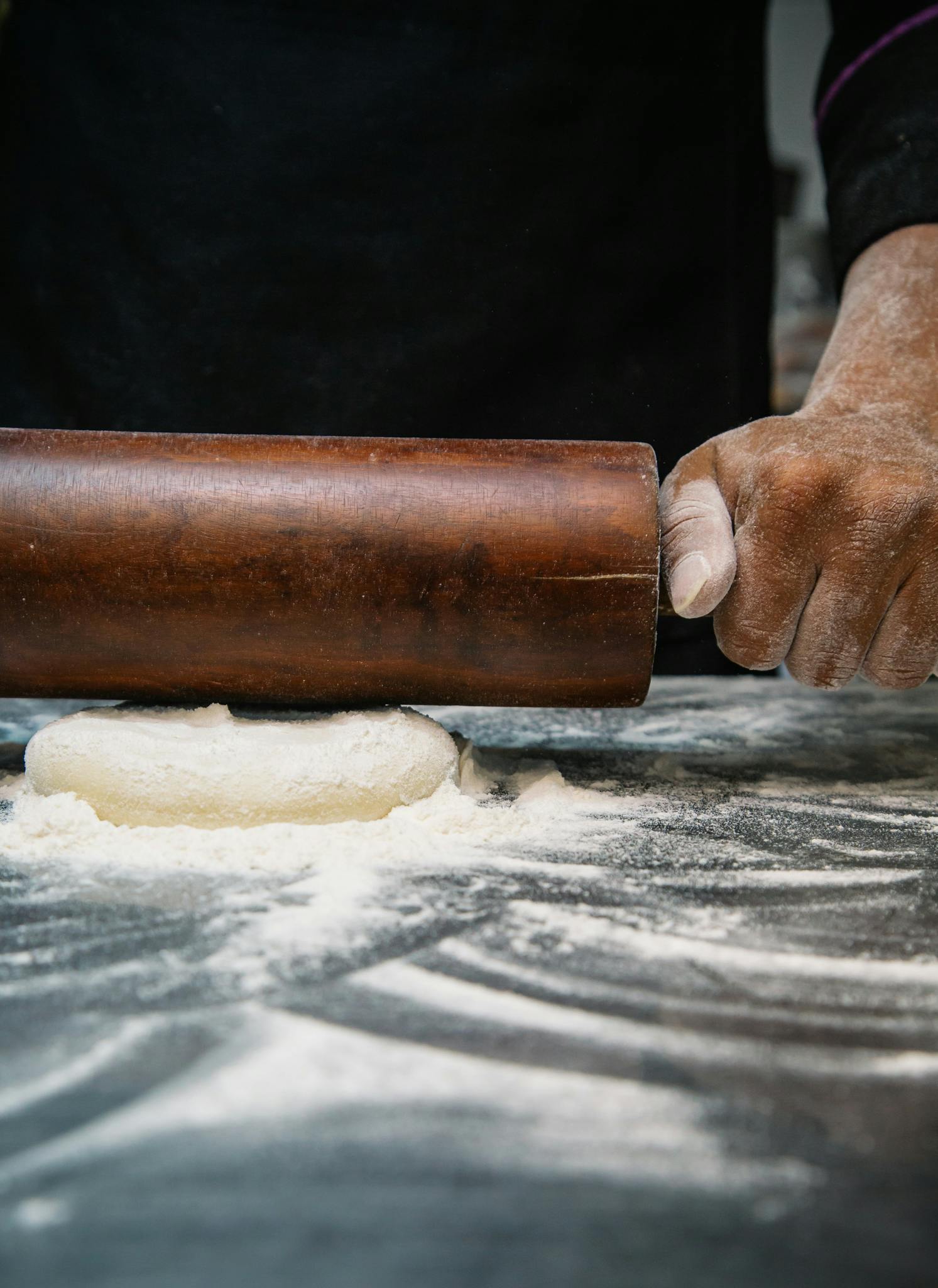 a person rolling out dough on a table, a portrait, by Matthias Stom, trending on unsplash, kek, extra detail, sichuan, profile image