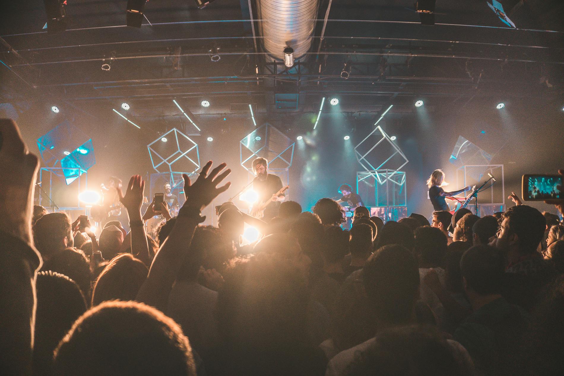 a crowd of people at a concert with their hands in the air, by Niko Henrichon, pexels contest winner, renaissance, william warehouse, thumbnail, multiple stories, lit from below