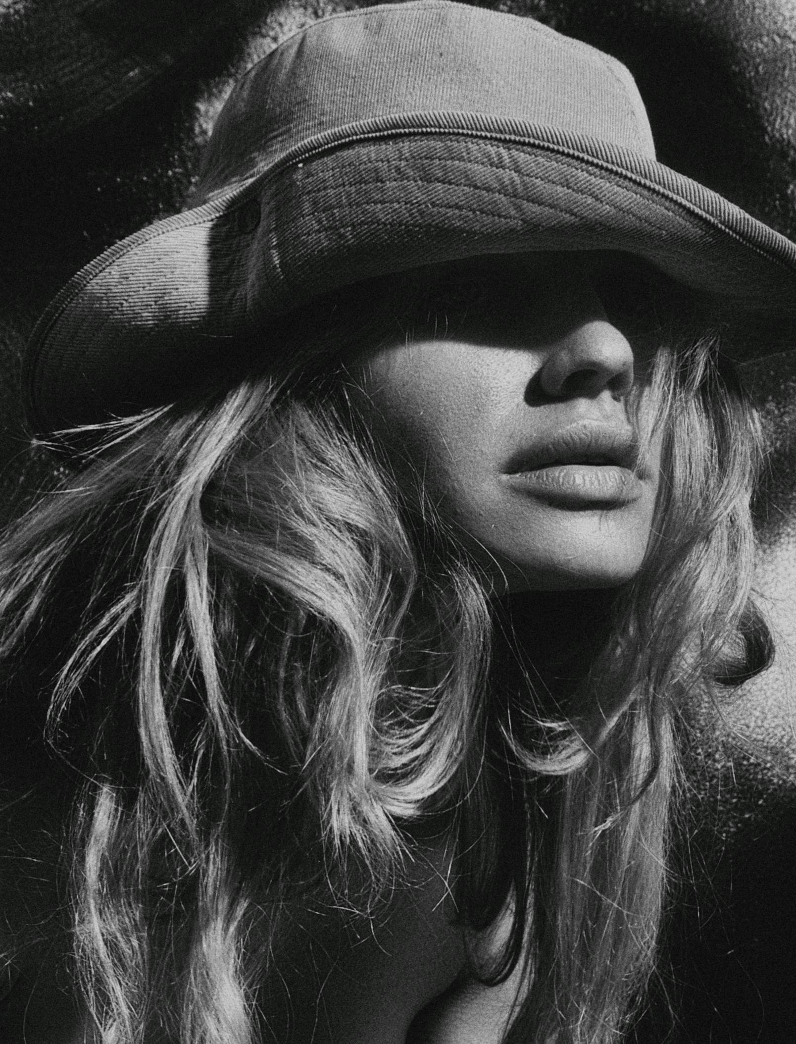 a black and white photo of a woman wearing a hat, inspired by Max Dupain, unsplash, photorealism, pamela anderson, amber heard, a blond, large)}]