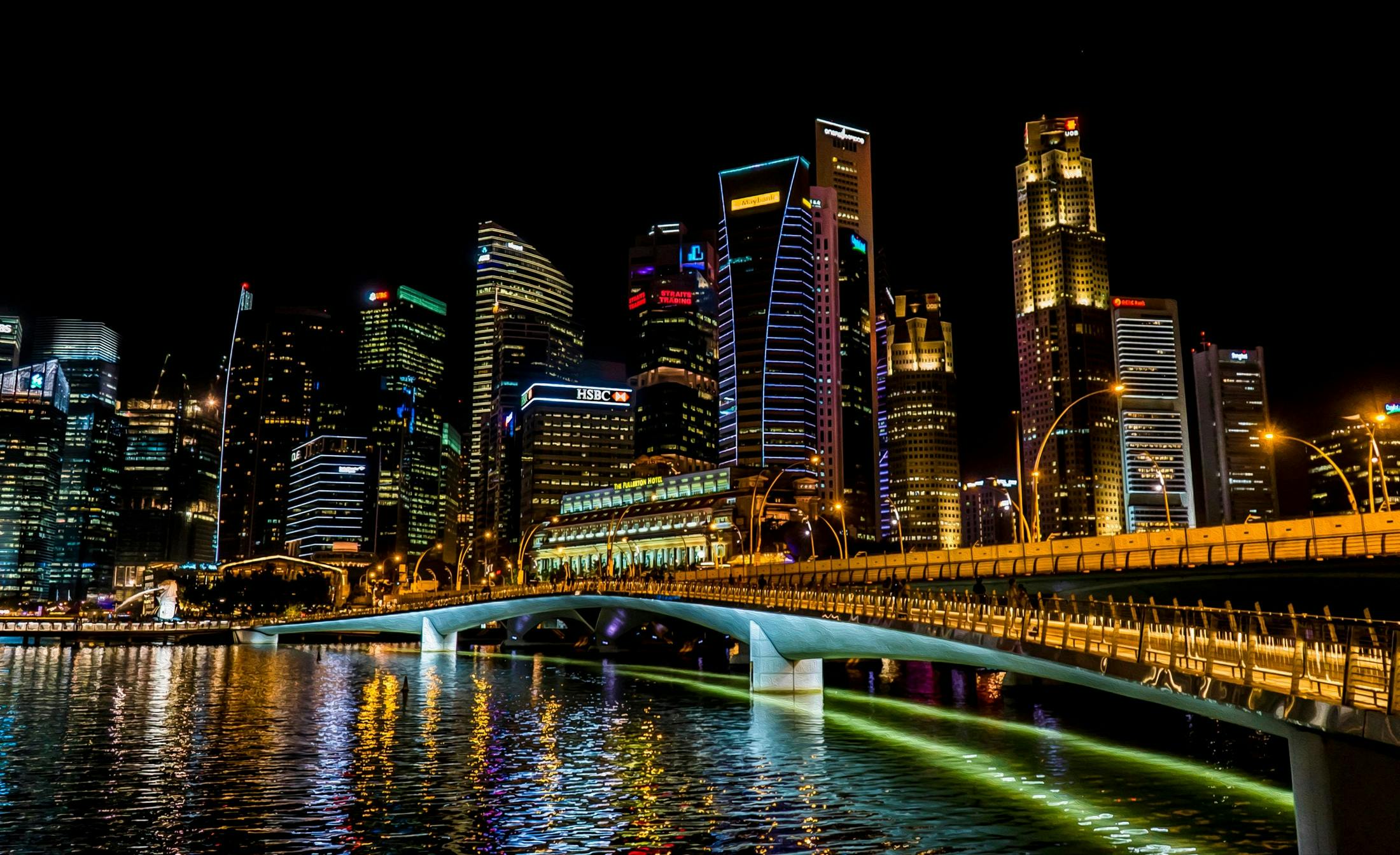 the city skyline is lit up at night, by Patrick Ching, pexels contest winner, hurufiyya, canal, nicely detailed, all buildings on bridge, marketing photo