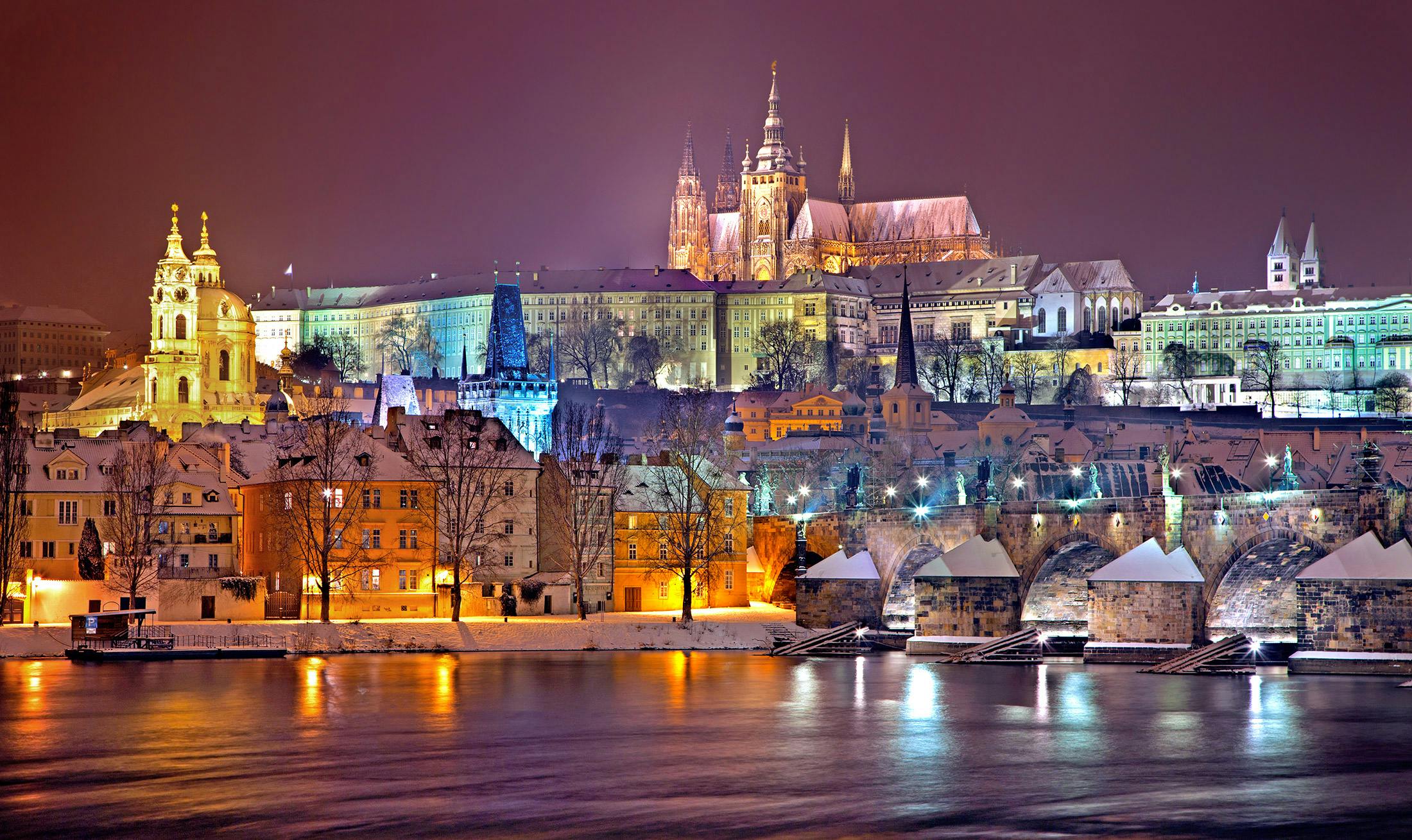 the city of prague is lit up at night, slide show, print, multicolored