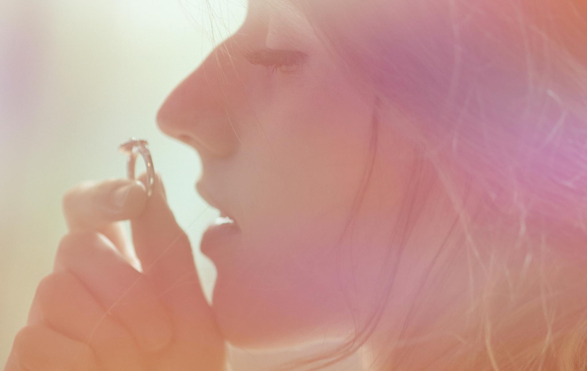 a woman brushing her teeth with a toothbrush, an album cover, inspired by Elsa Bleda, trending on pexels, aestheticism, outline glow lens flare, the ring, close - up profile face, sunfaded