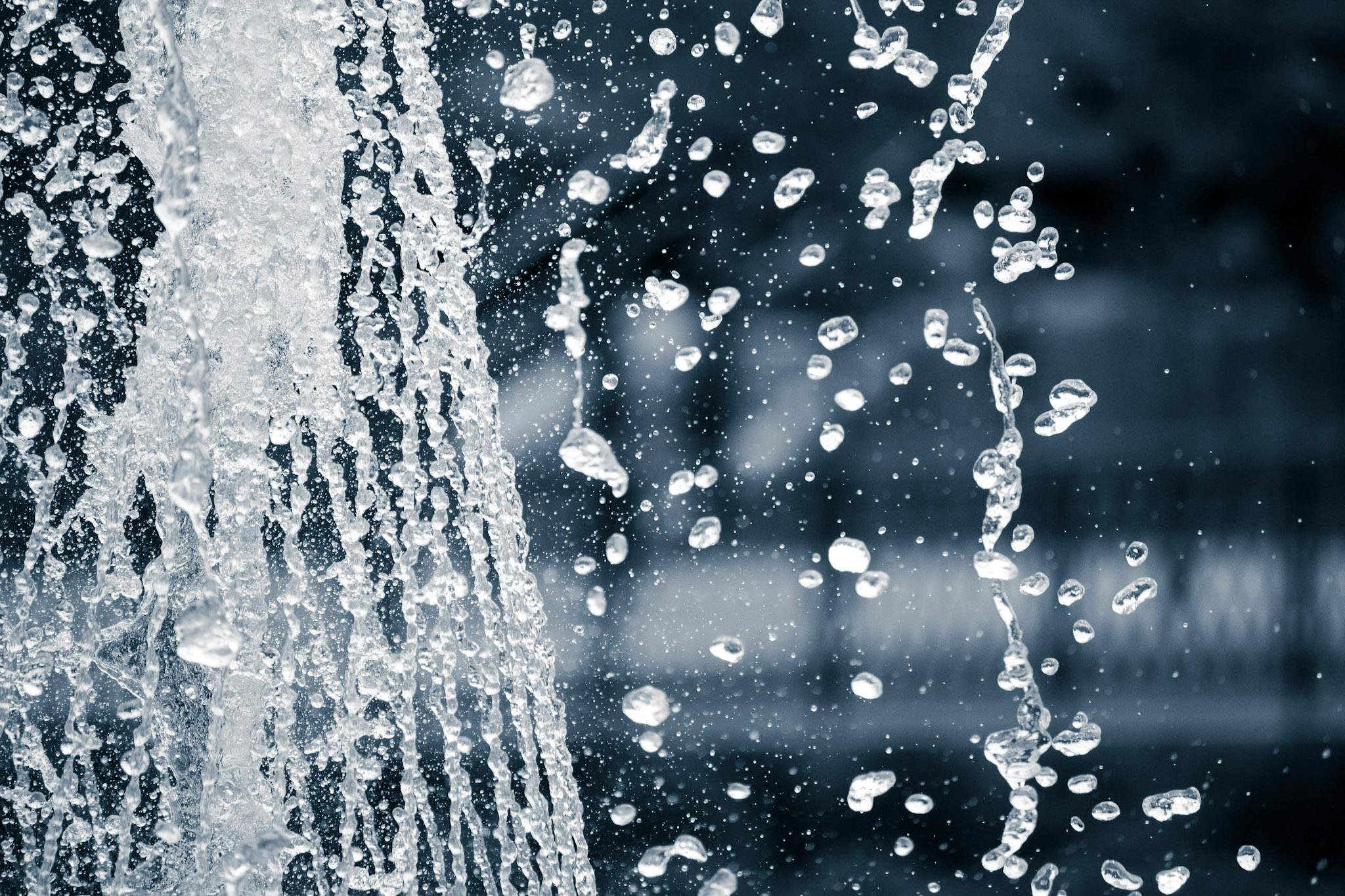 a black and white photo of a water fountain, an album cover, unsplash, lots of bubbles, icicle, detailed screenshot, showers