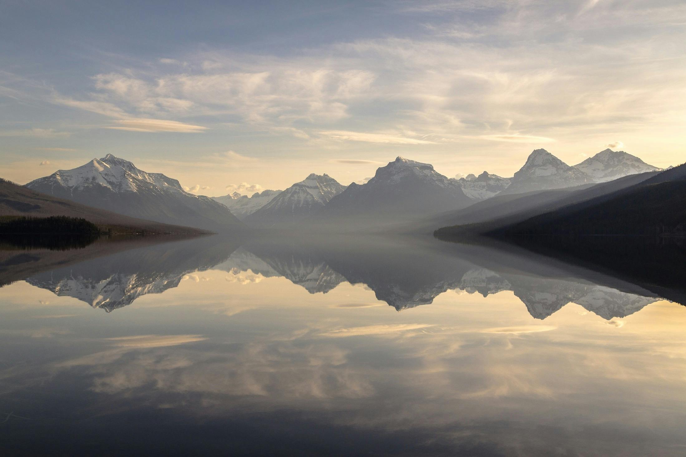 a body of water with mountains in the background, by Jessie Algie, pexels contest winner, mirror world, morning light, glacier national park, 8k resolution”