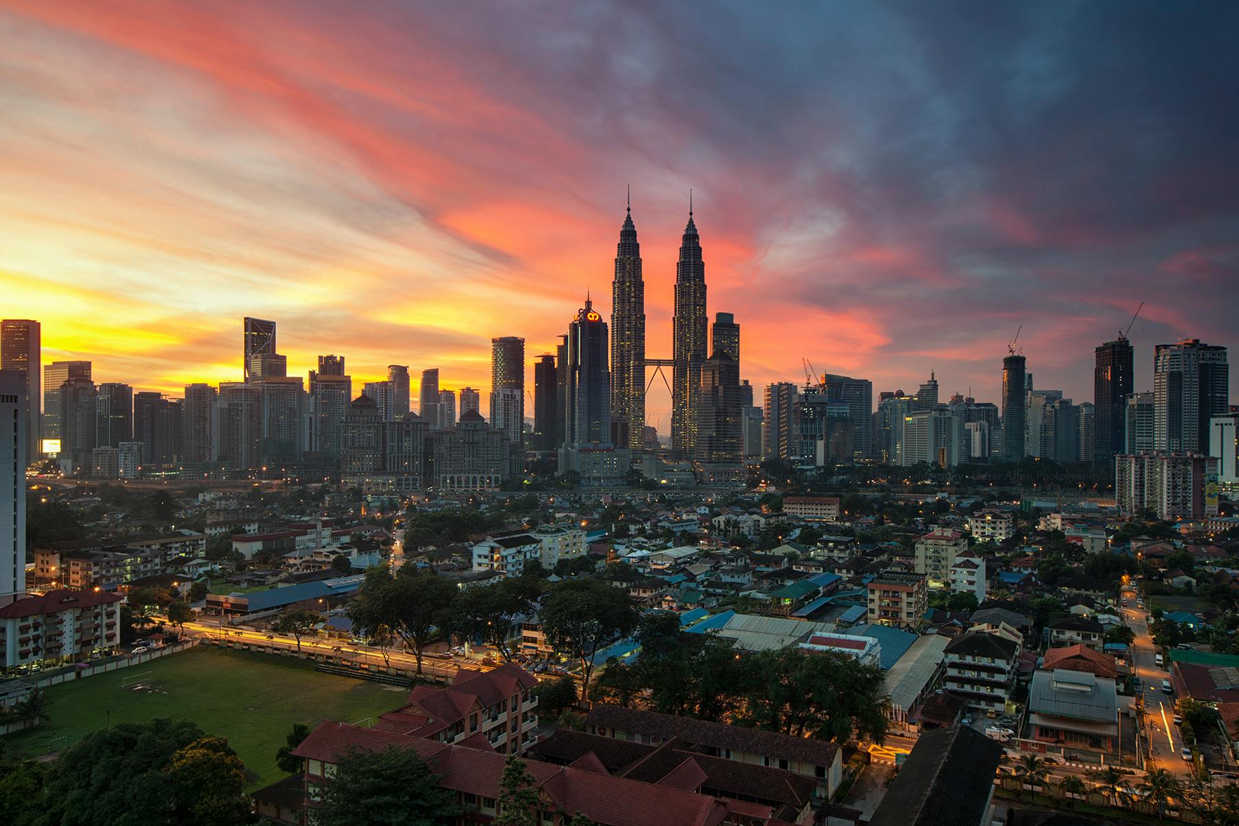 a cityscape with a sunset in the background, by Bernardino Mei, pexels contest winner, hurufiyya, malaysian, majestic spires, panorama, bright sunny day