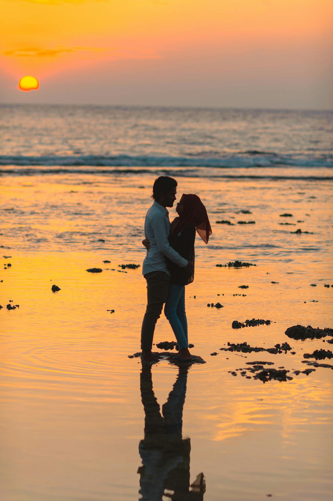 a couple kissing on the beach at sunset, indonesia, taken in 2 0 2 0, tall, oman