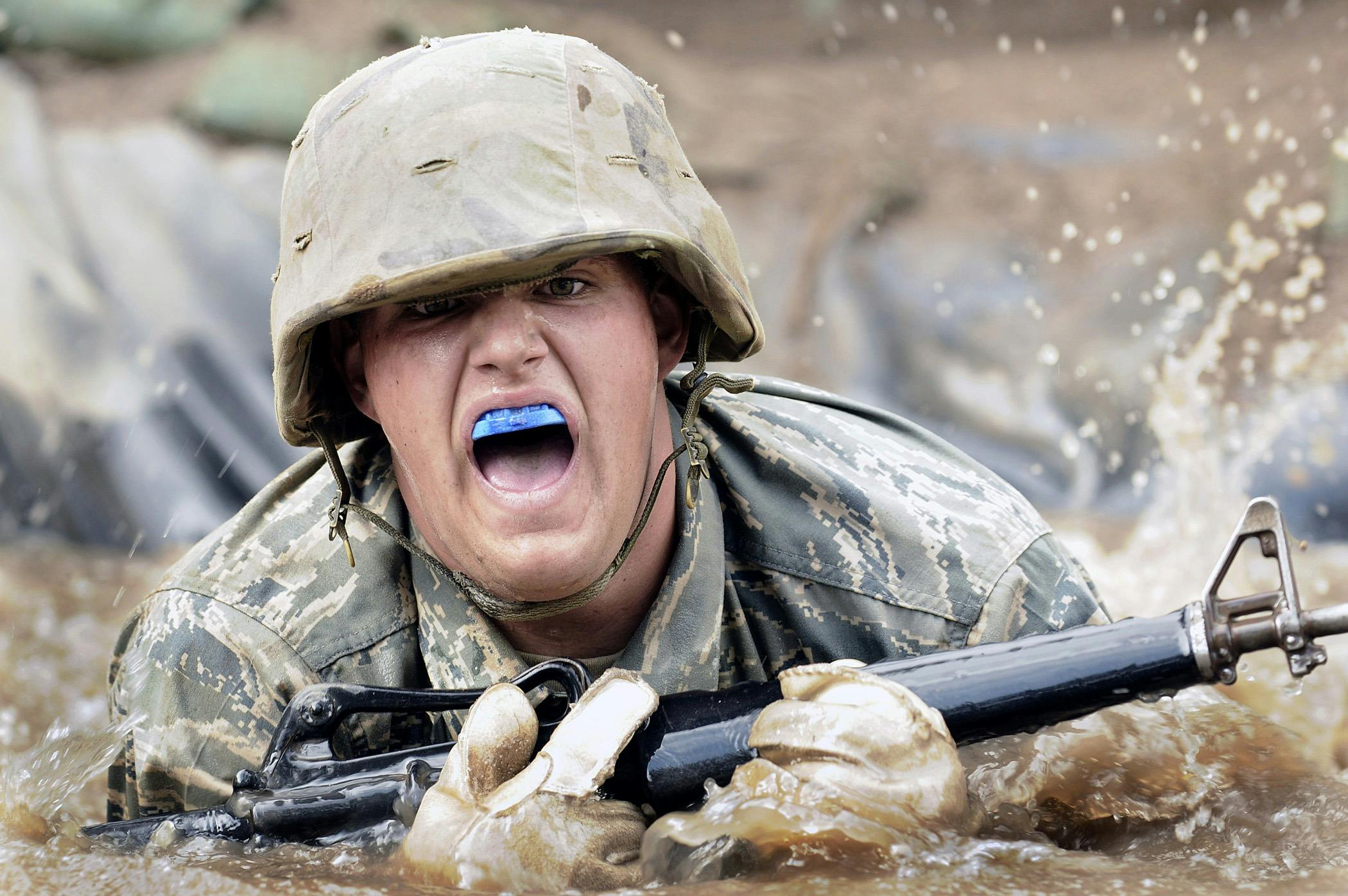 a soldier with a blue tongue sticking out of his mouth, unsplash, photorealism, splashing, pokemon military drill, wet mud, slide show