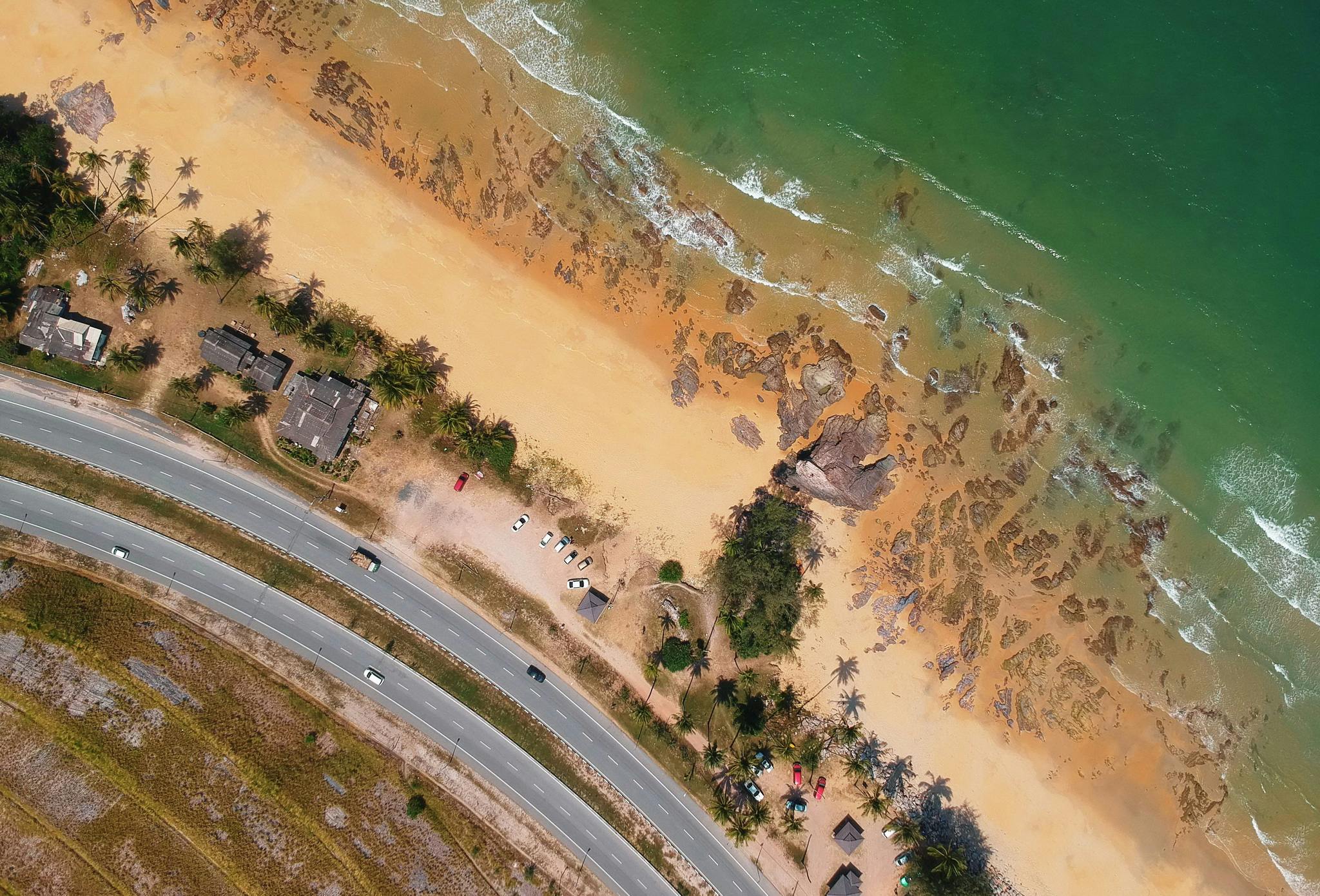 an aerial view of a beach next to the ocean, by Lee Loughridge, pexels contest winner, photorealism, sri lanka, sandy colors, video footage, road trip