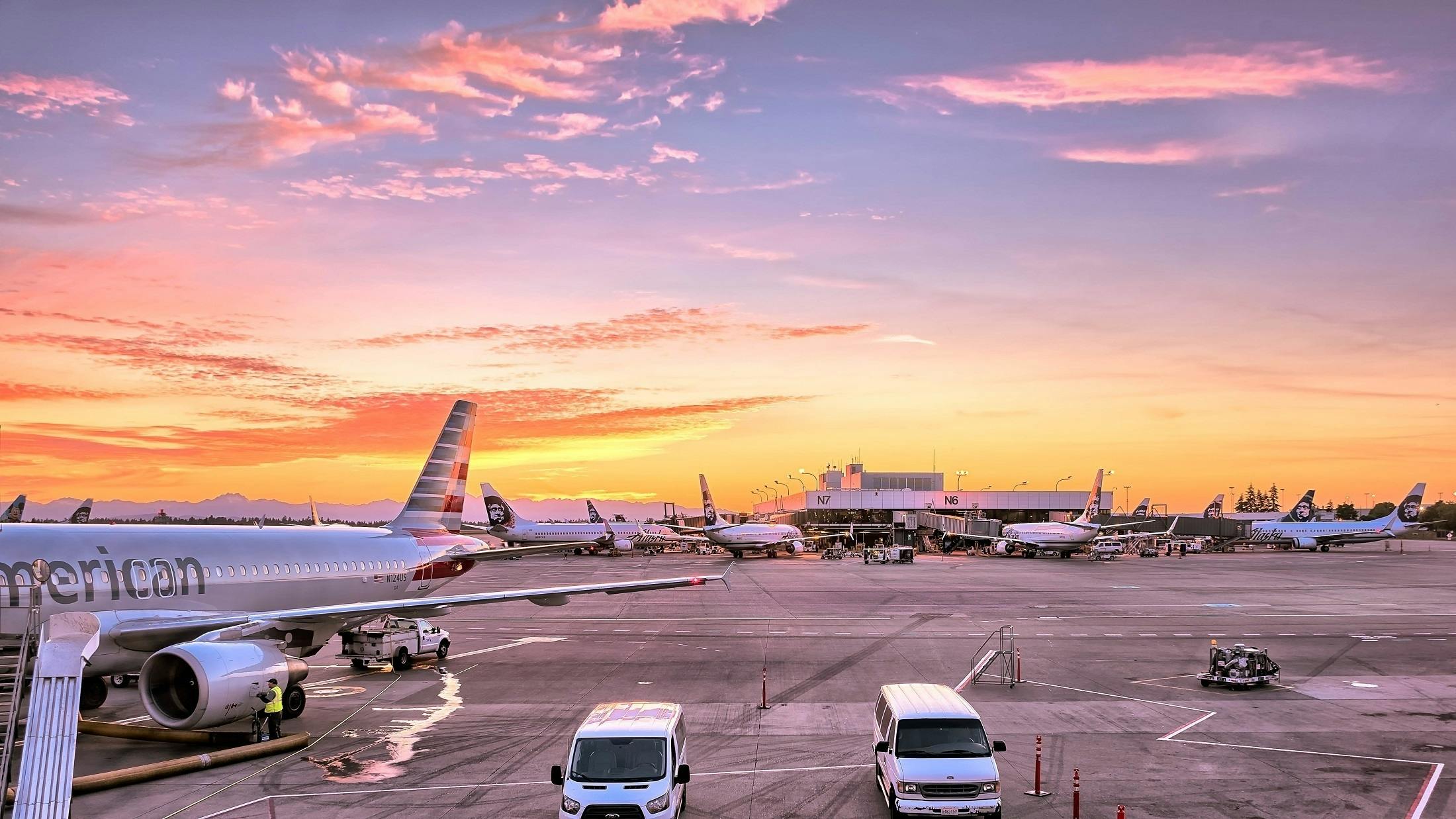 a large jetliner sitting on top of an airport tarmac, by Carey Morris, pexels contest winner, pink skies, flying cars, 3 - piece, rectangle