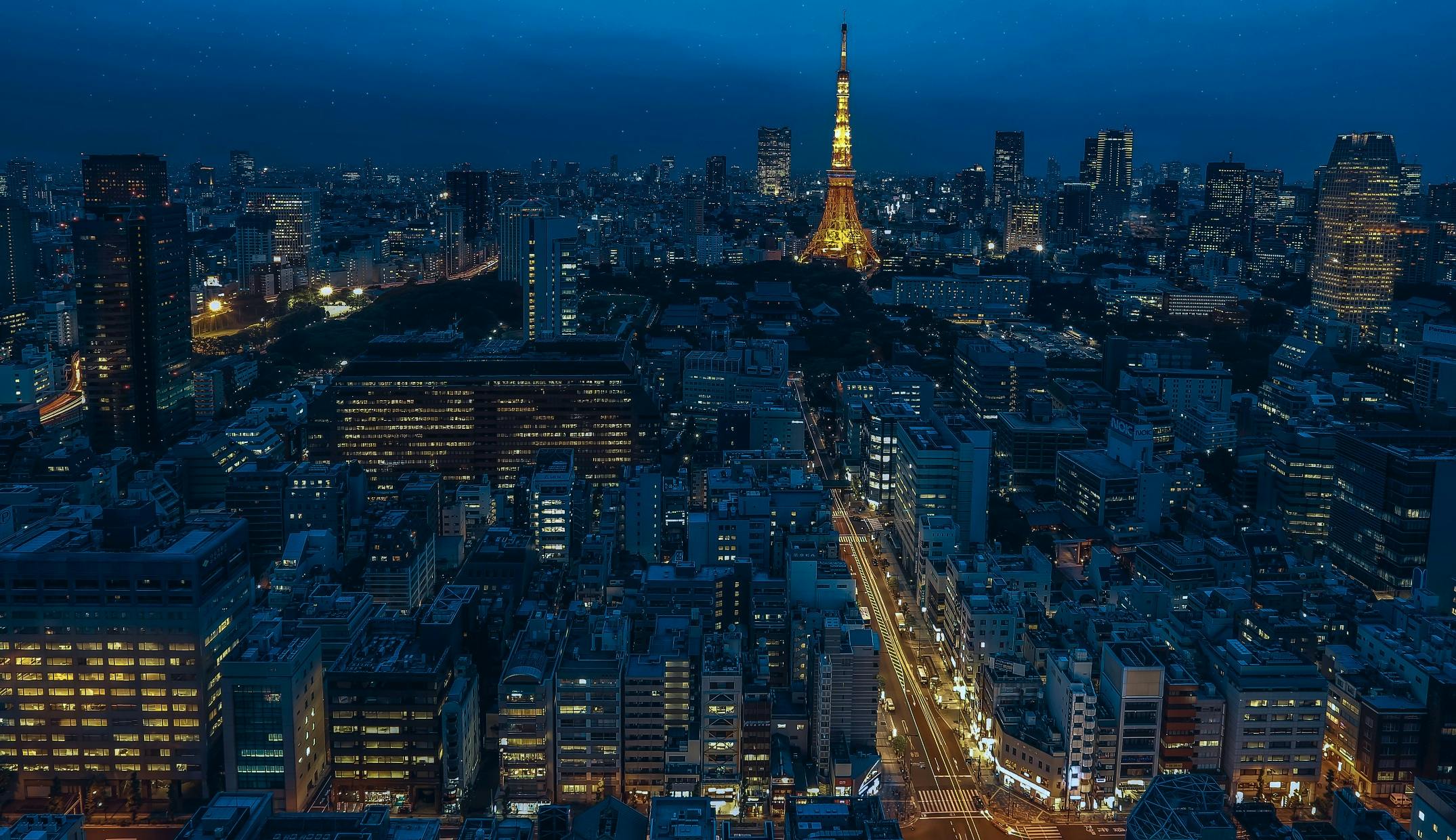 an aerial view of a city at night, by Tadashi Nakayama, pexels contest winner, european japanese buildings, slide show, ad image