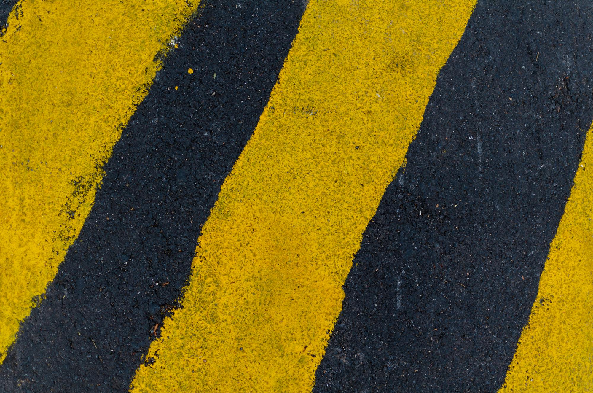 a red fire hydrant sitting on the side of a road, an album cover, by Carey Morris, unsplash, black. yellow, hd detailed texture, hazard stripes, square