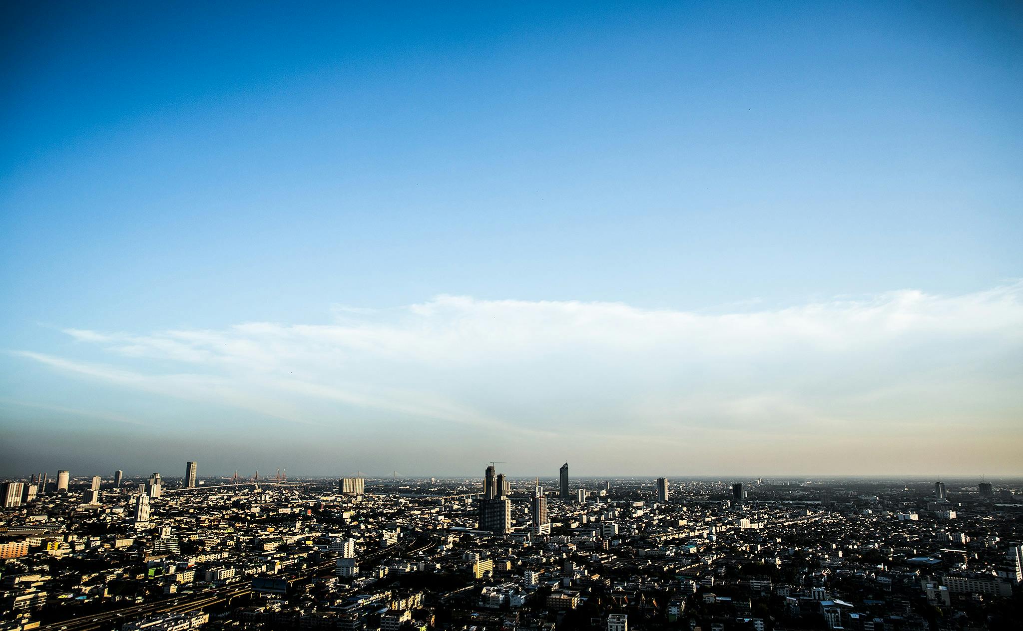 a view of a city from the top of a building, by Tobias Stimmer, unsplash, blue and clear sky, paris 2010, slide show, large sky