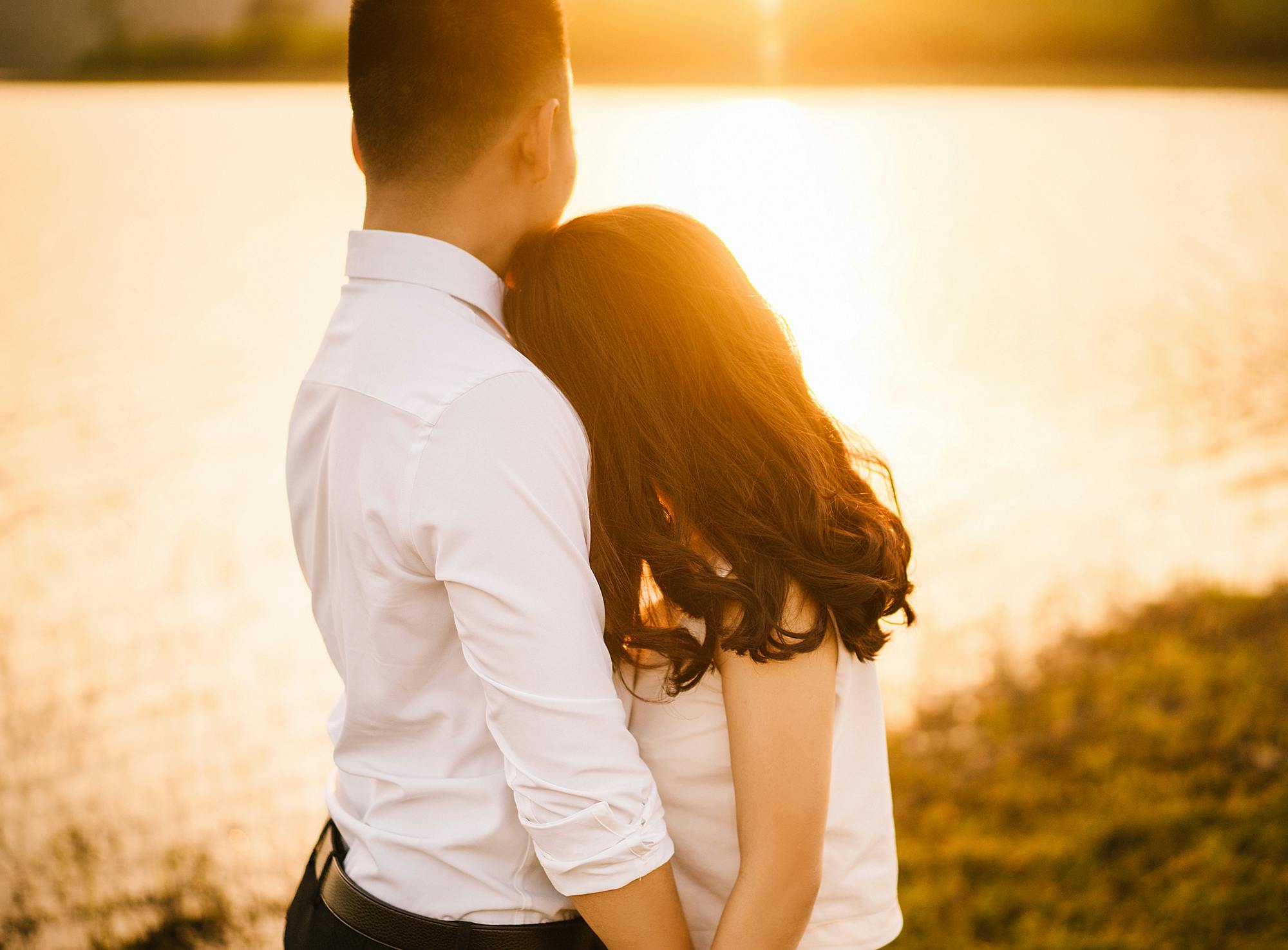 a man and a woman standing next to each other, pexels contest winner, romanticism, (golden hour), asian women, sweet hugs, youtube thumbnail