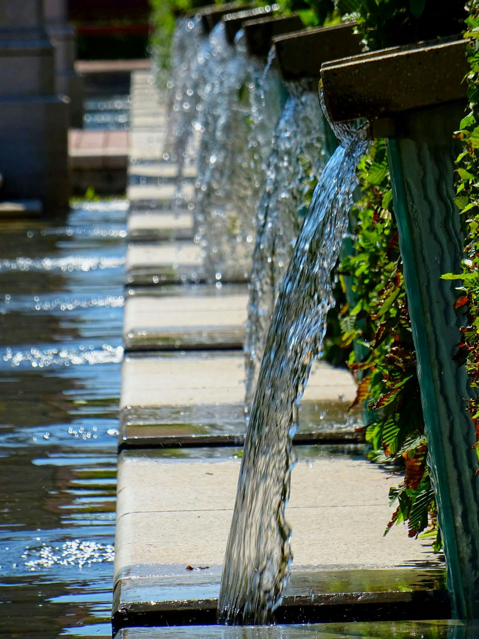 a close up of a fountain with water coming out of it, canals, thumbnail, in a row, overlooking