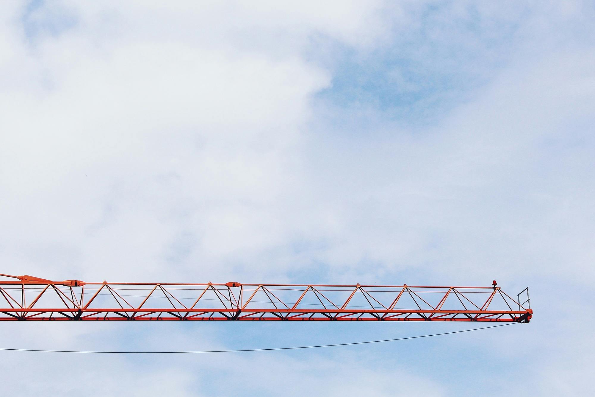 a large red crane sitting on top of a building, by Carey Morris, unsplash, constructivism, sky bridge, blue, medium closeup, promo image