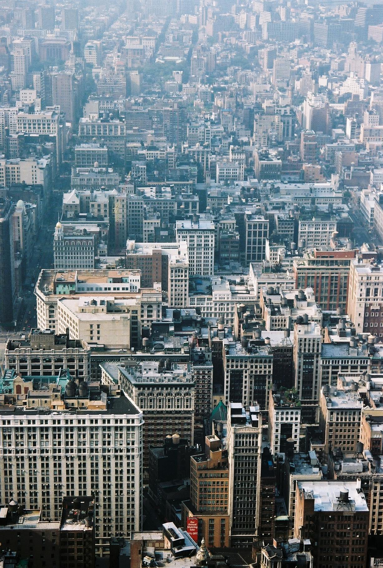a view of a city from the top of a building, by Nina Hamnett, trending on unsplash, modernism, new york buildings, expansive detailed layered city, 2000s photo, savannah