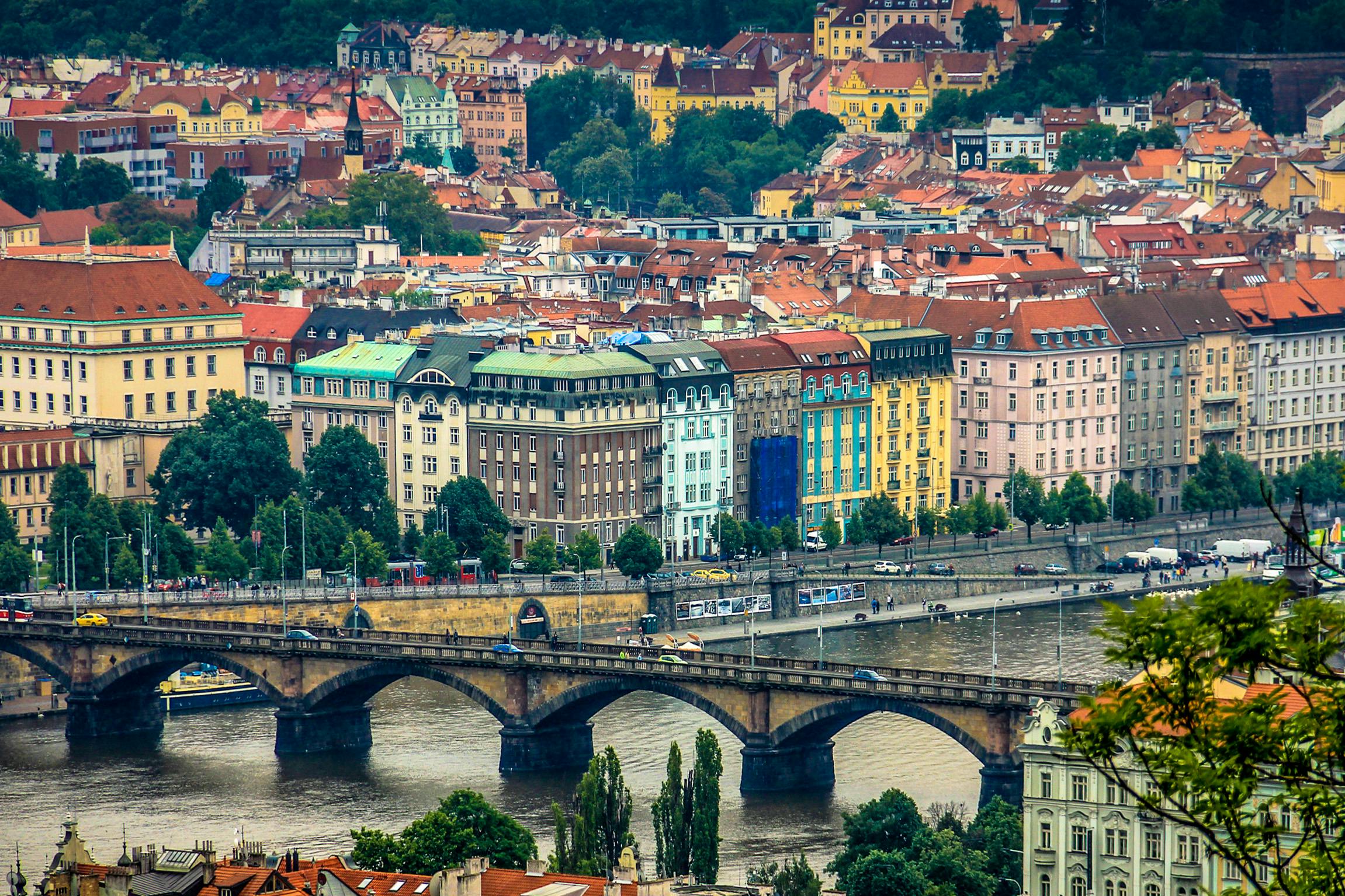a view of a city from the top of a hill, by Adam Marczyński, pexels contest winner, art nouveau, all buildings on bridge, colorful”, square, 1990's photo