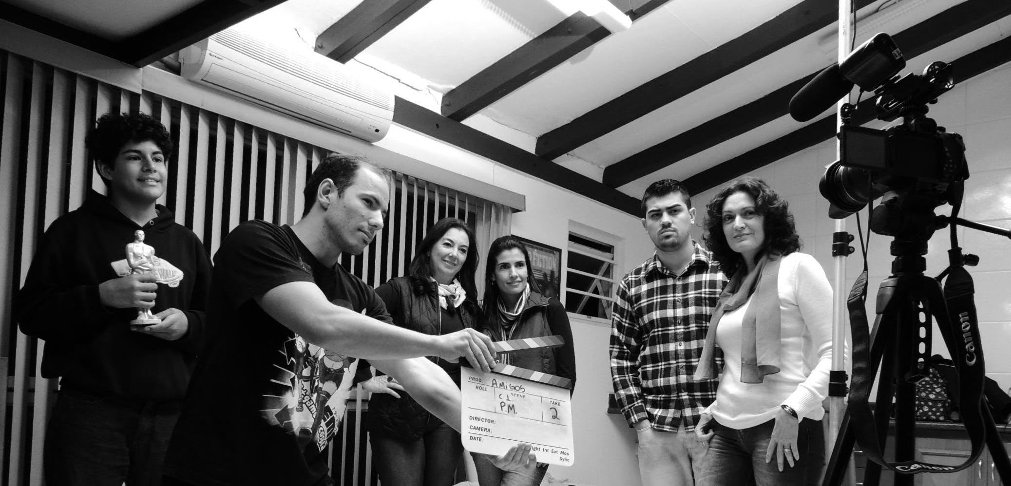 a group of people standing in front of a camera, a black and white photo, by Ramón Silva, an escape room in a small, !!!award-winning!!!, presenting wares, storyboarding