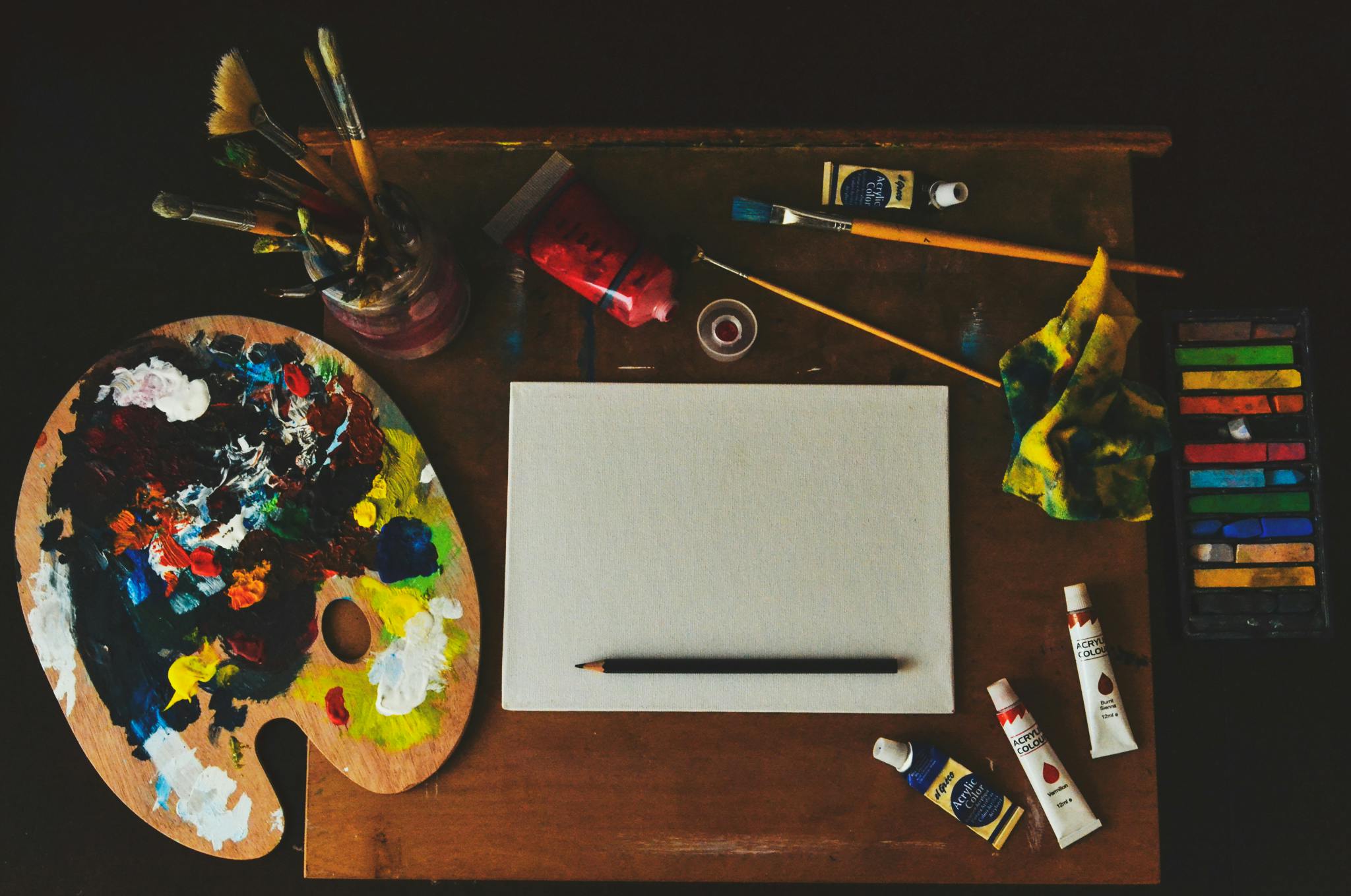 a wooden table topped with lots of art supplies, inspired by artist, pexels contest winner, fan favorite, painting, easel, a wooden