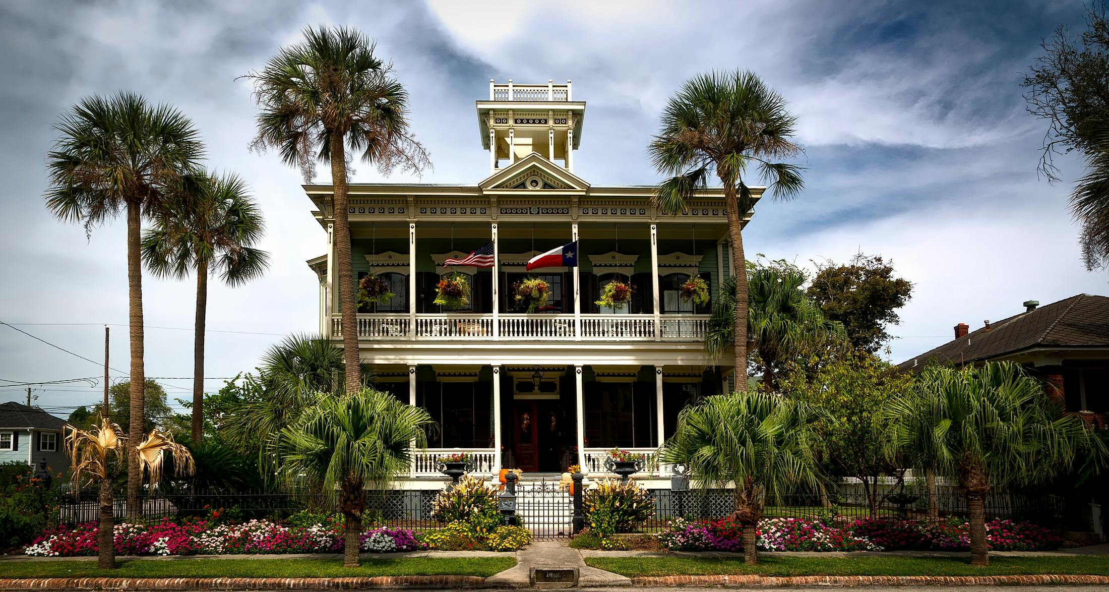 a large house with palm trees in front of it, by Carey Morris, pexels contest winner, southern wildflowers, preserved historical, americana architecture, coastal