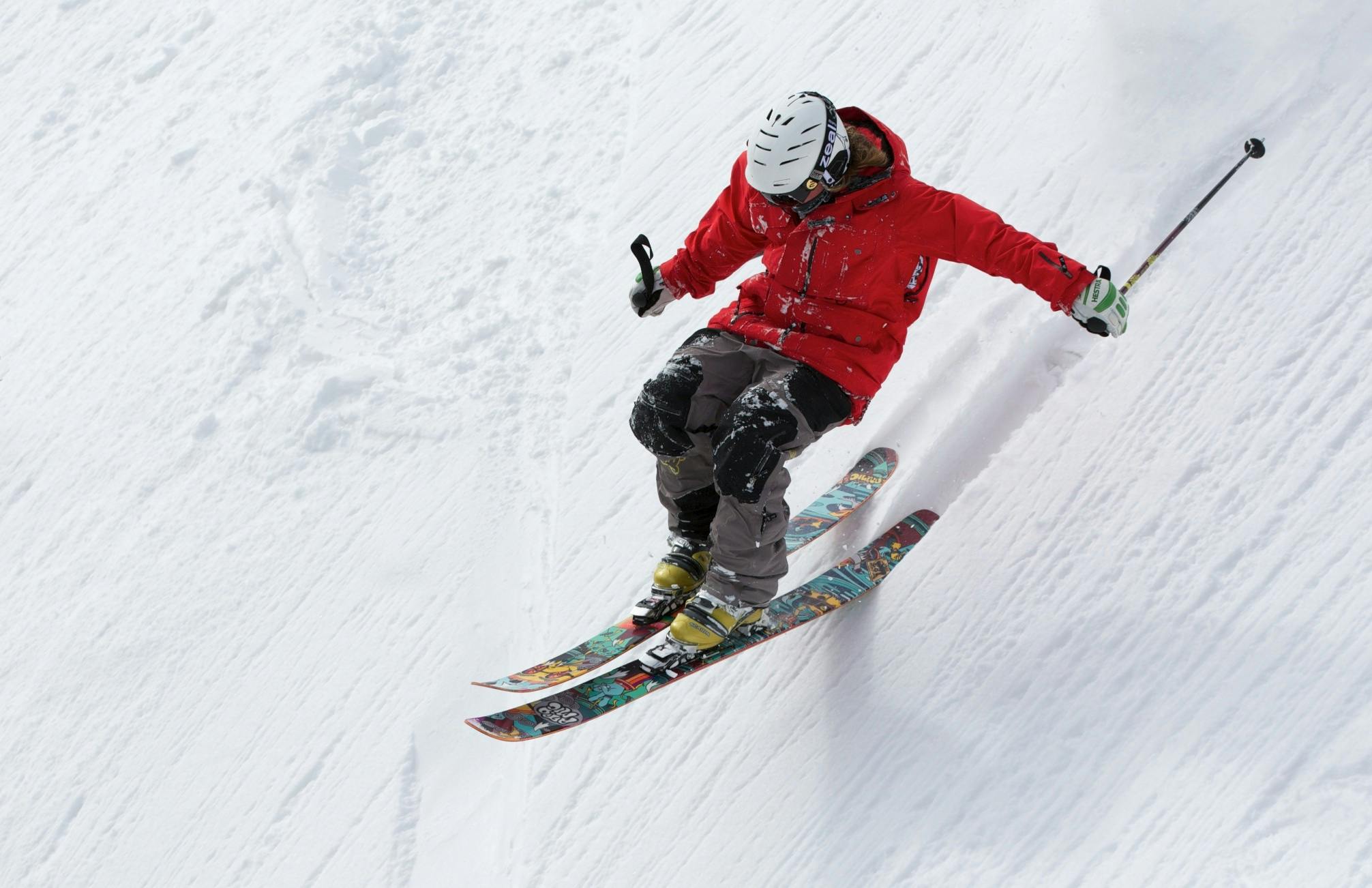 a man riding skis down the side of a snow covered slope, pexels contest winner, figuration libre, panels, maroon, advanced technology, white