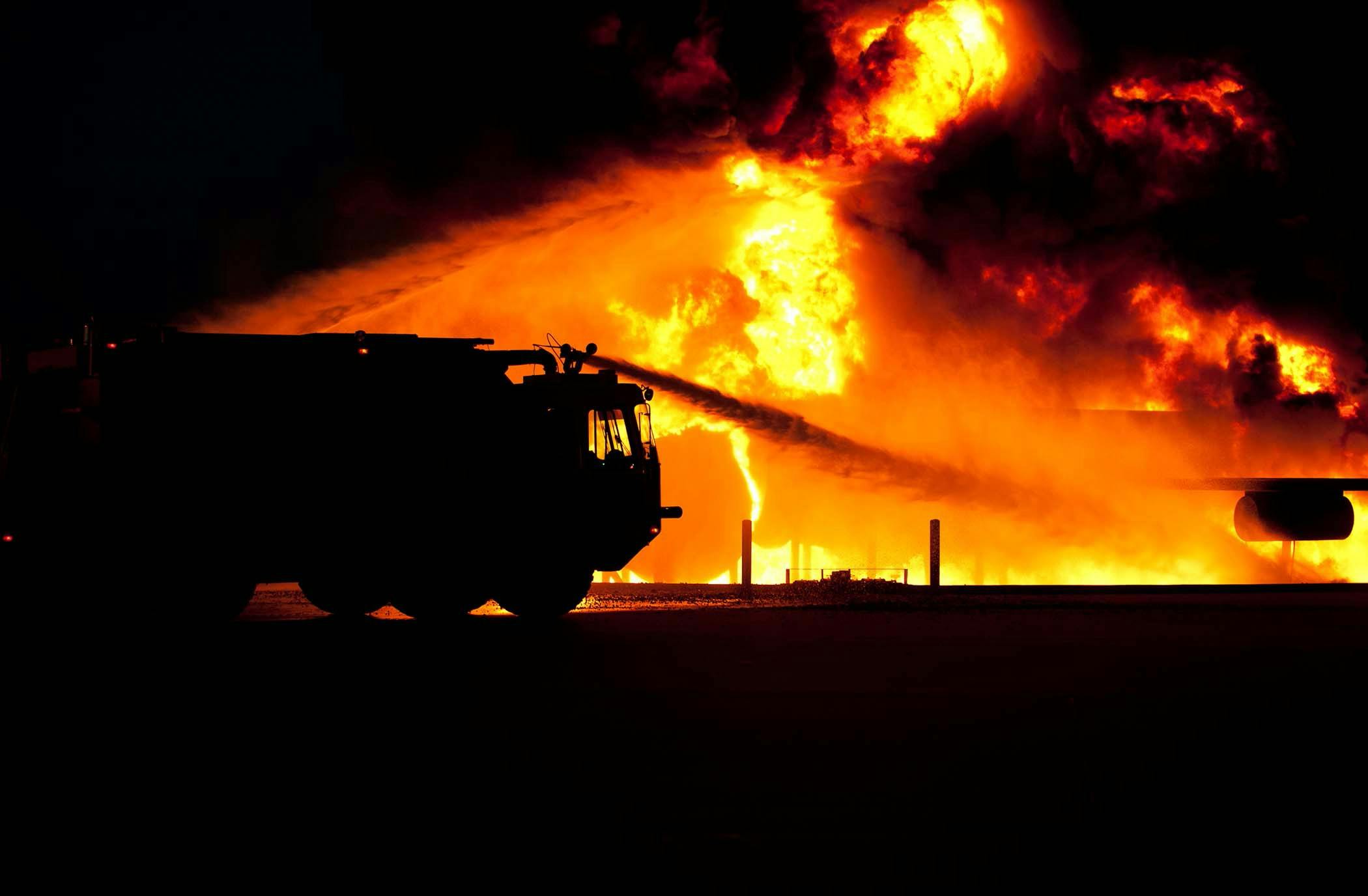 a fire truck spraying water on a large fire, a photo, pexels contest winner, profile picture 1024px, demolition, beautifully lit, high quality photo