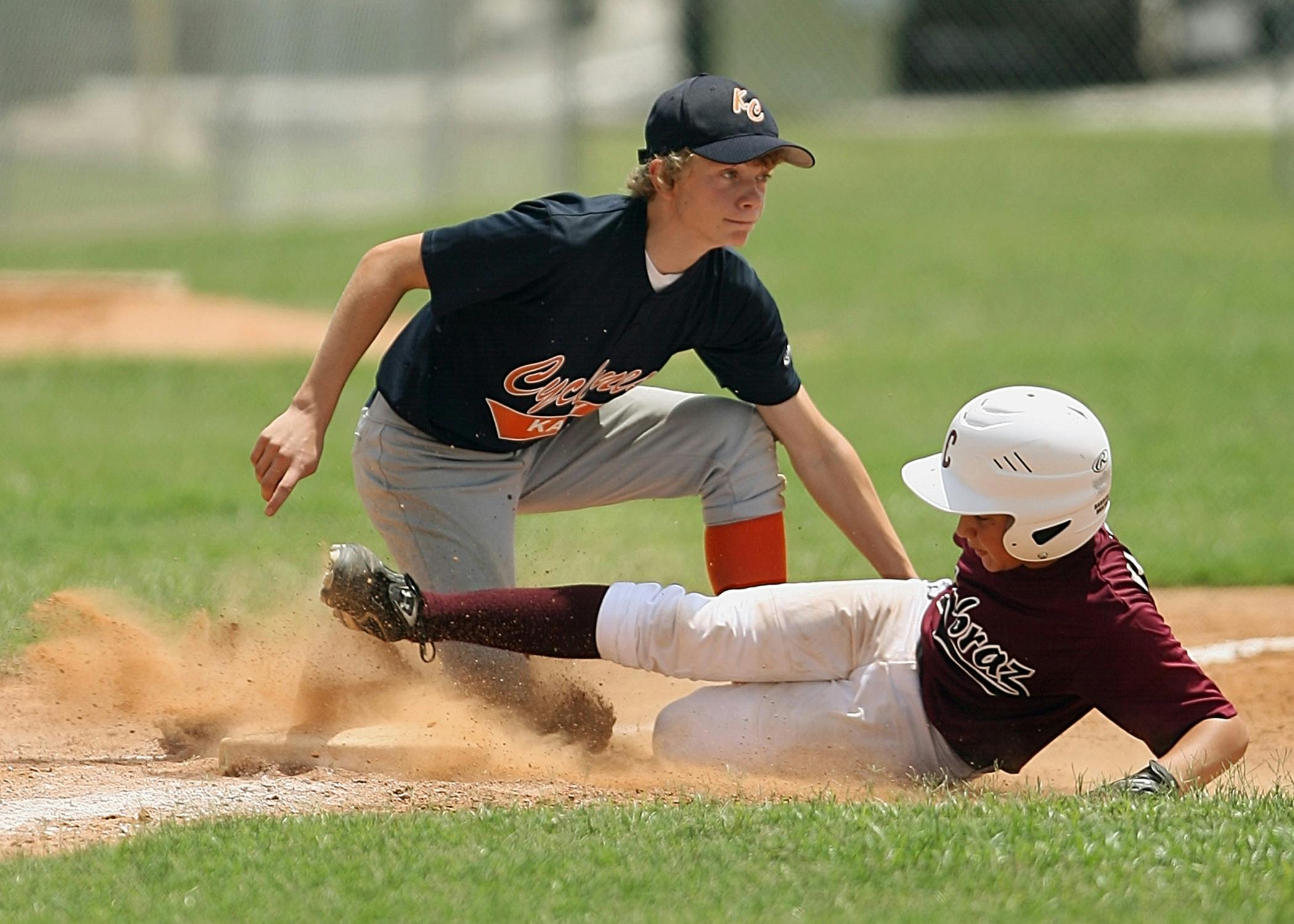 a baseball player sliding into a base during a game, by Scott M. Fischer, pexels contest winner, maroon, teenage boy, complaints, promo image