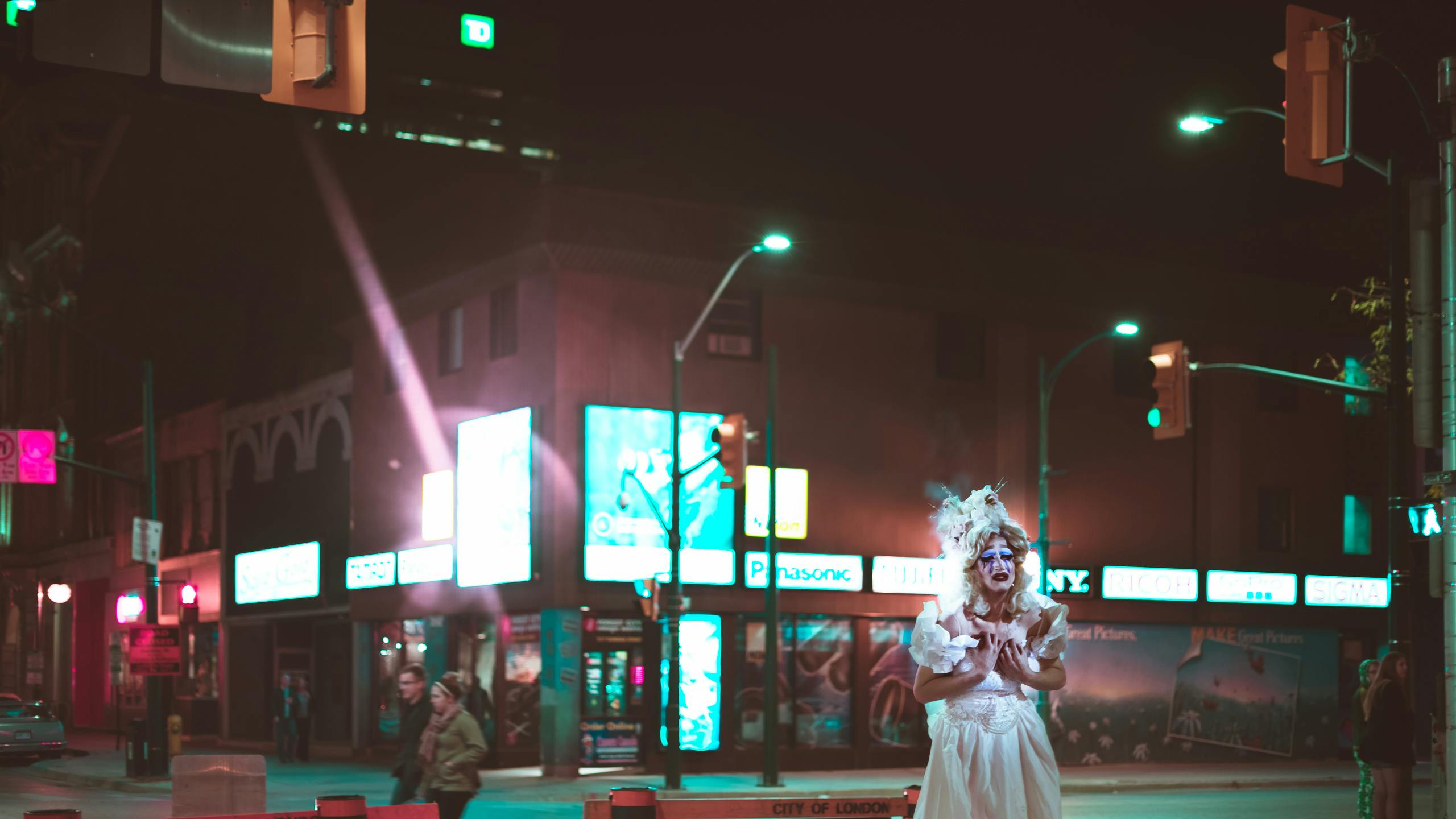 a woman standing in the middle of a street at night, a statue, inspired by Elsa Bleda, pexels contest winner, man dressed as a chicken, toronto, scary clown, performing a music video