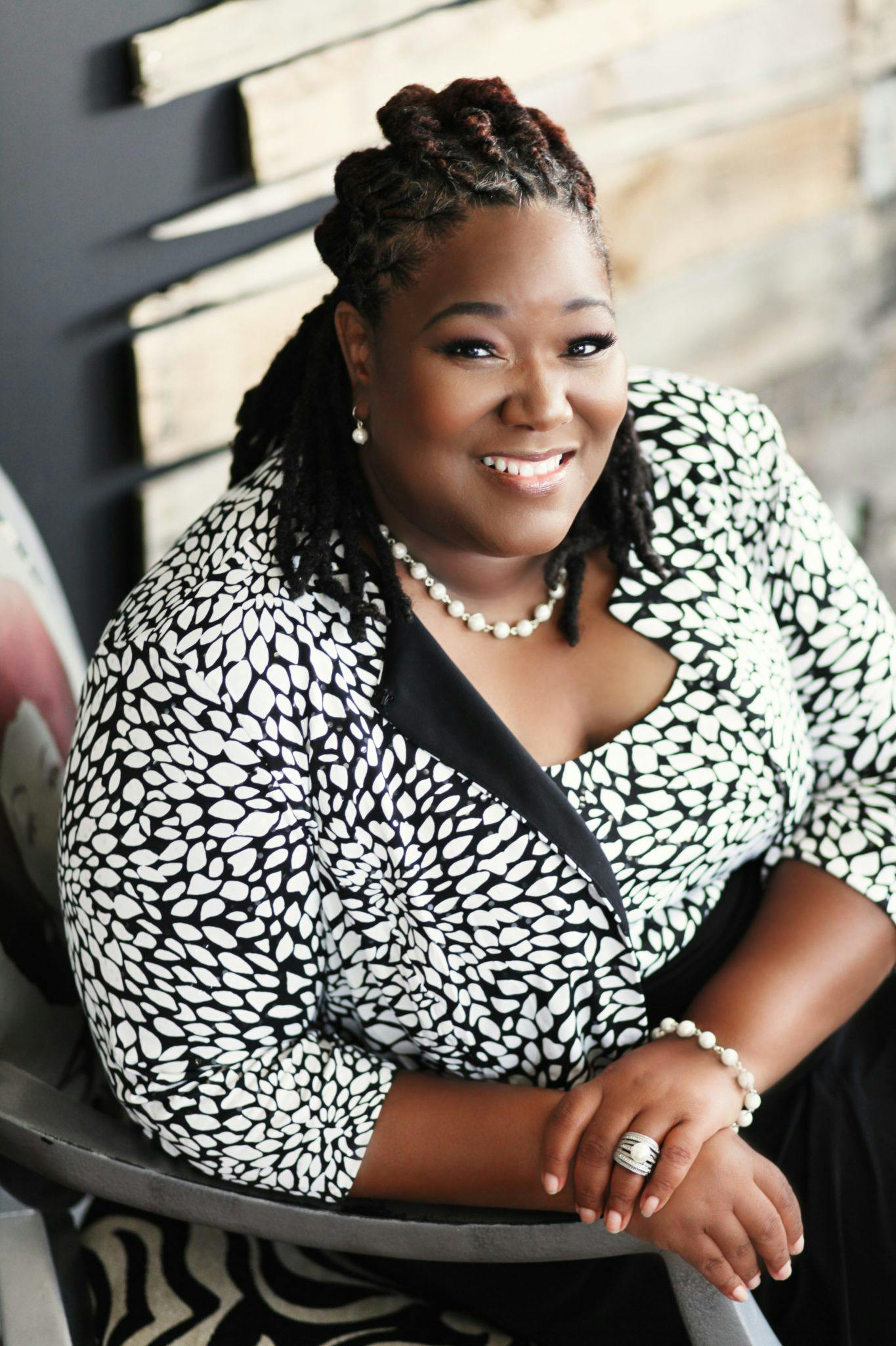 a woman sitting in a chair smiling at the camera, trending on bbwchan, black in, portrait”, profile image