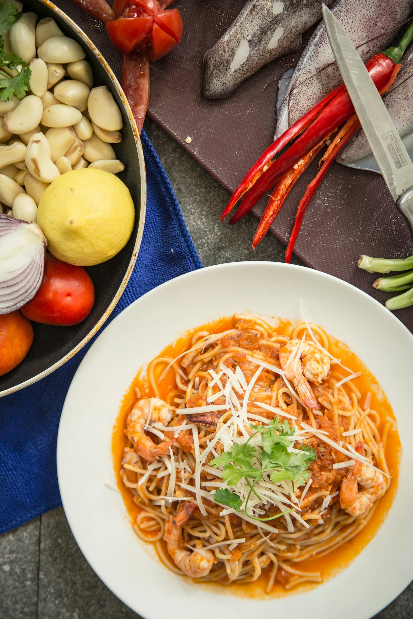 a close up of a plate of food on a table, inspired by Tan Ting-pho, pexels contest winner, renaissance, square, spaghetti, prawn, brown