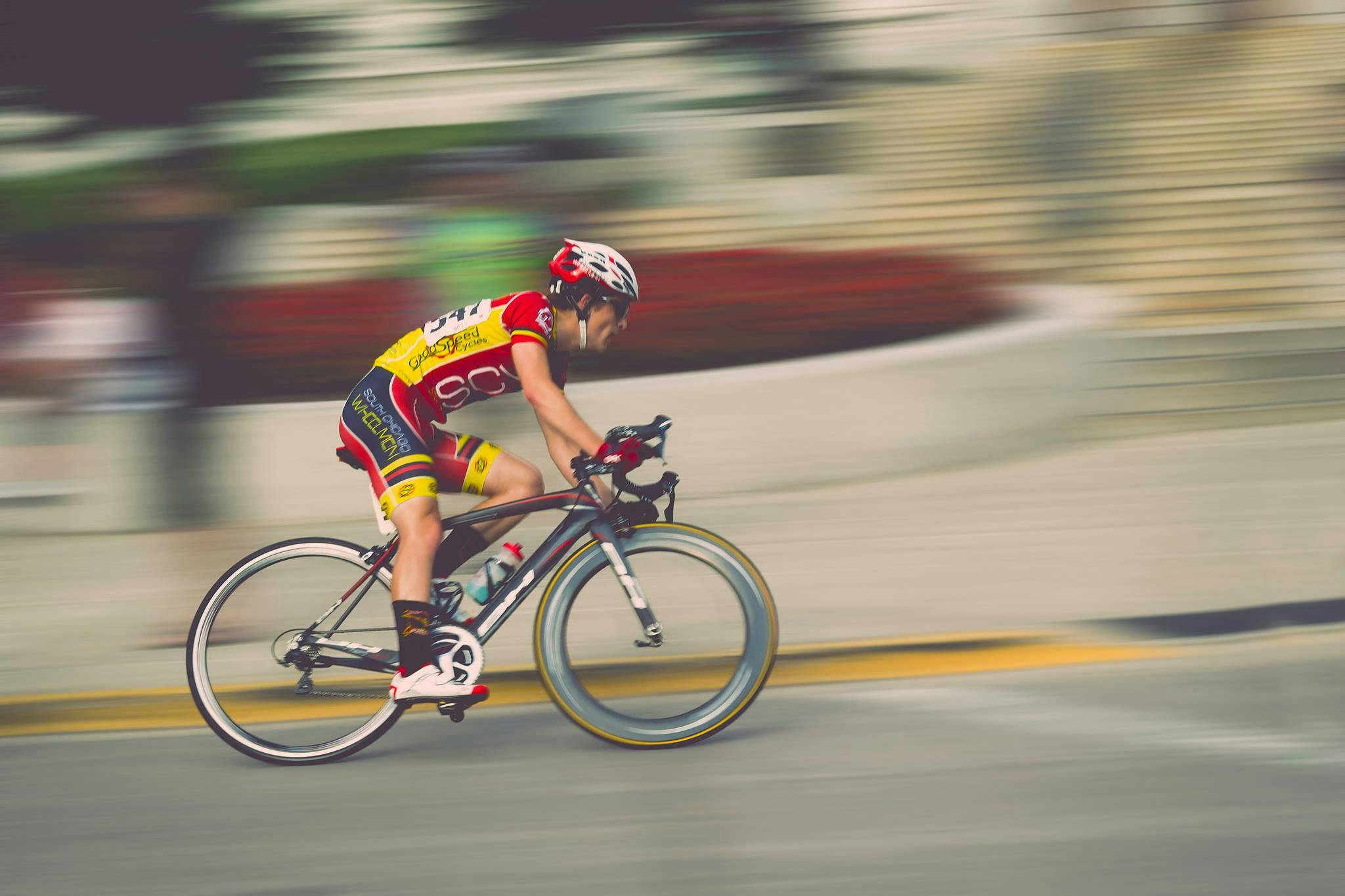 professional cyclist speeding on street in urban setting