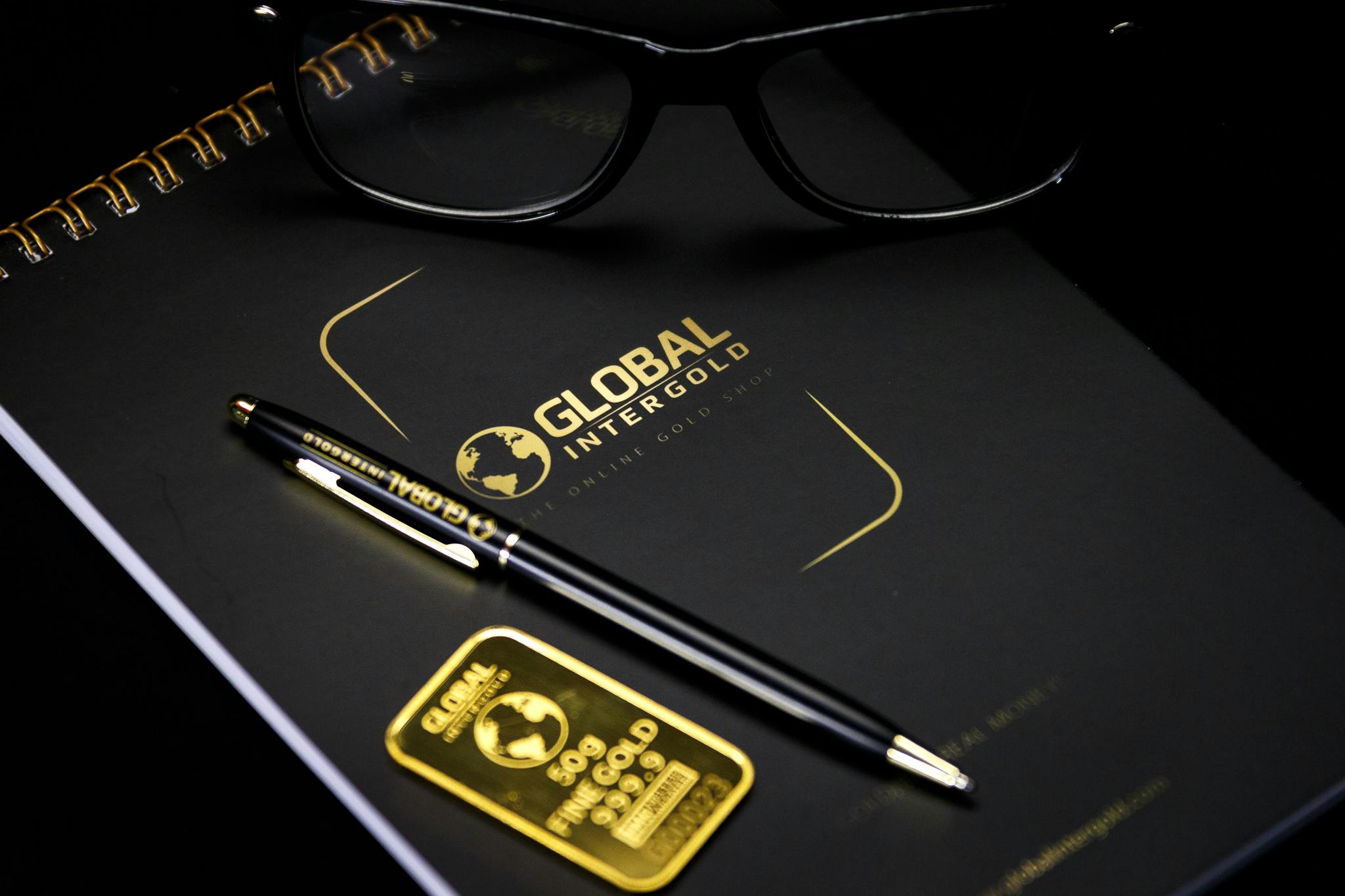a pen and glasses sitting on top of a book