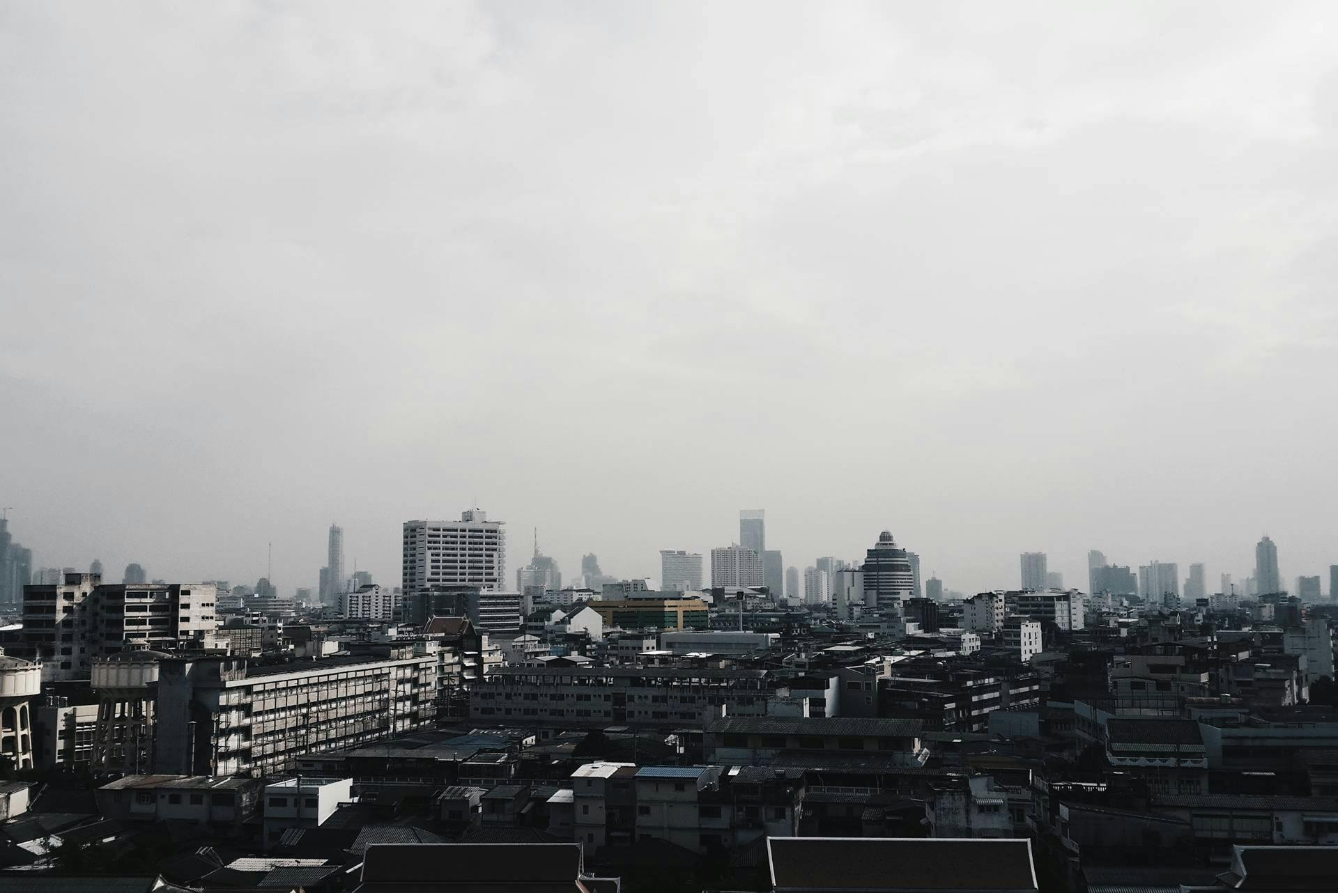 city skyline under cloudy skies and some skyscrs