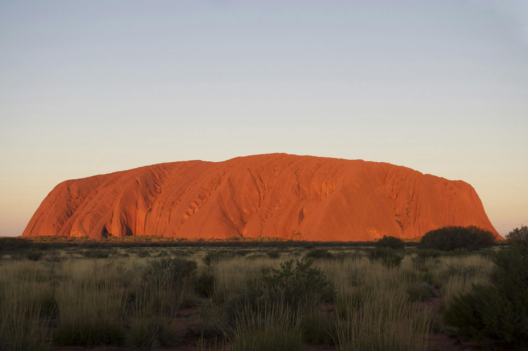 the sun shines behind ulpenet - colored rock formations